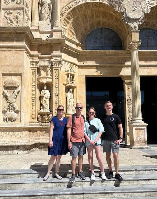 A family outside of an intricately carved church