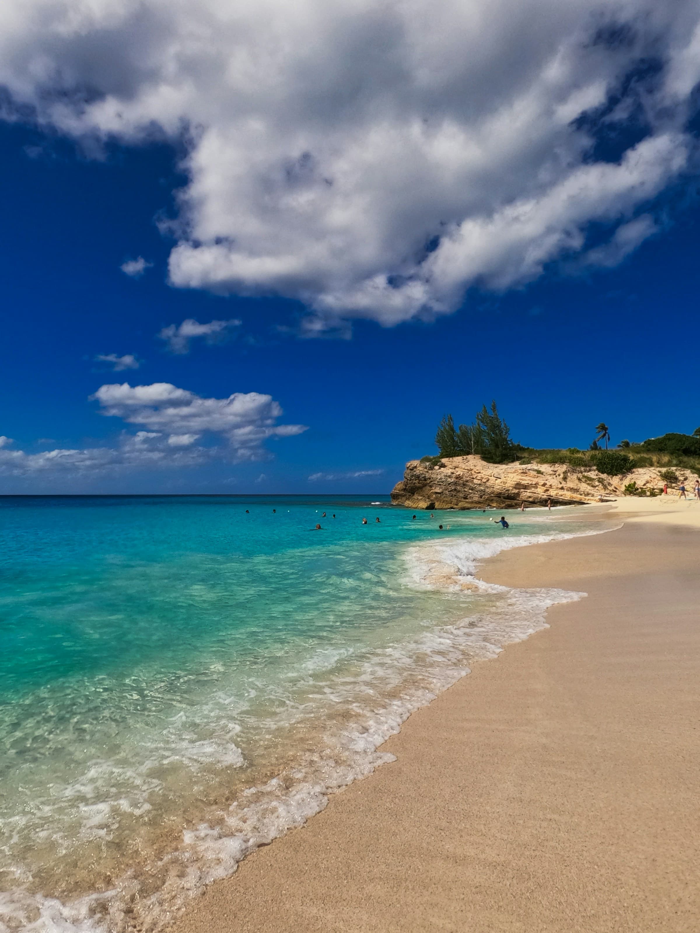A sandy beach with clear blue water at Sint Maarten.