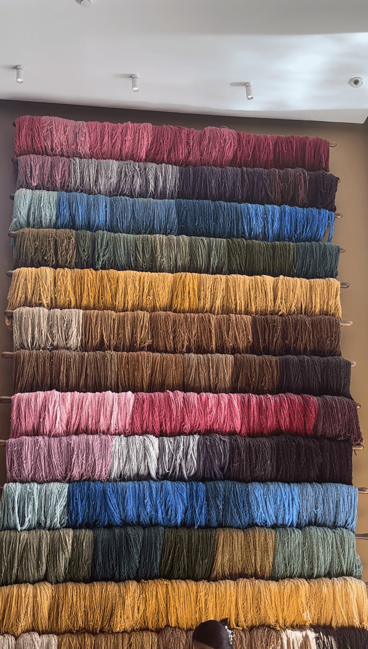 A wall of multicolored textiles