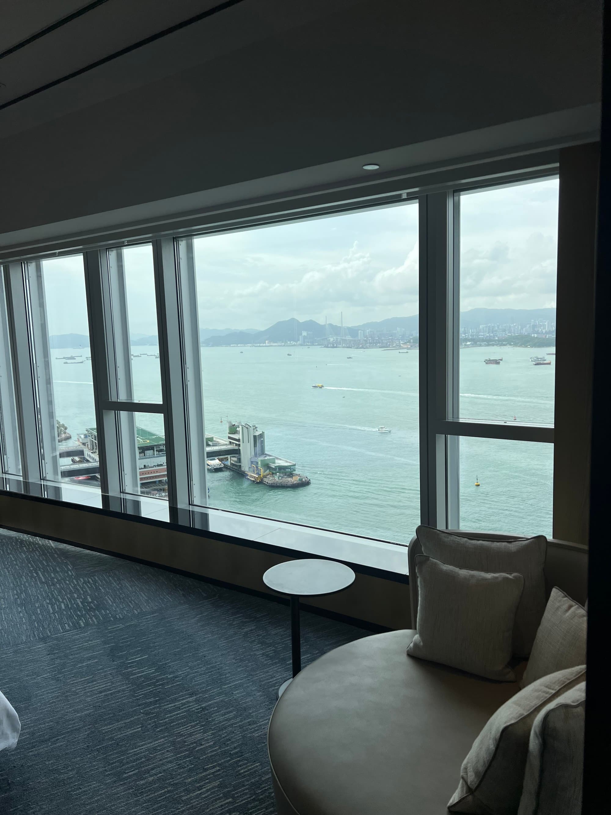 A view of the water from the hotel room window on a sunny day.