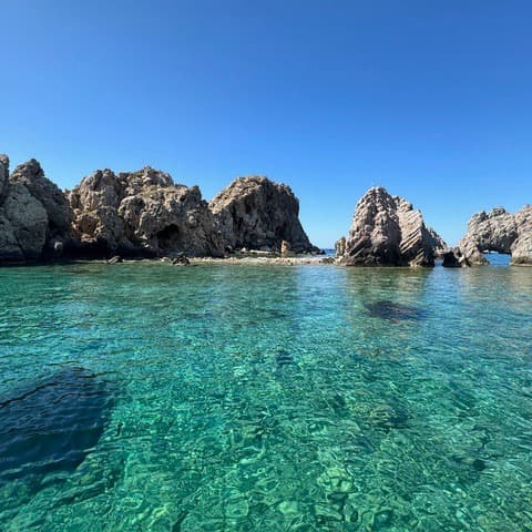 Rock formations on green water.