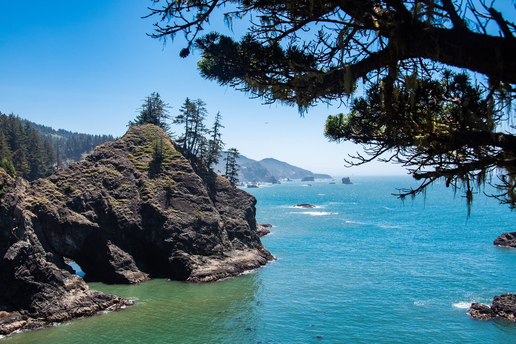 rocky coastline next to body of water during daytime