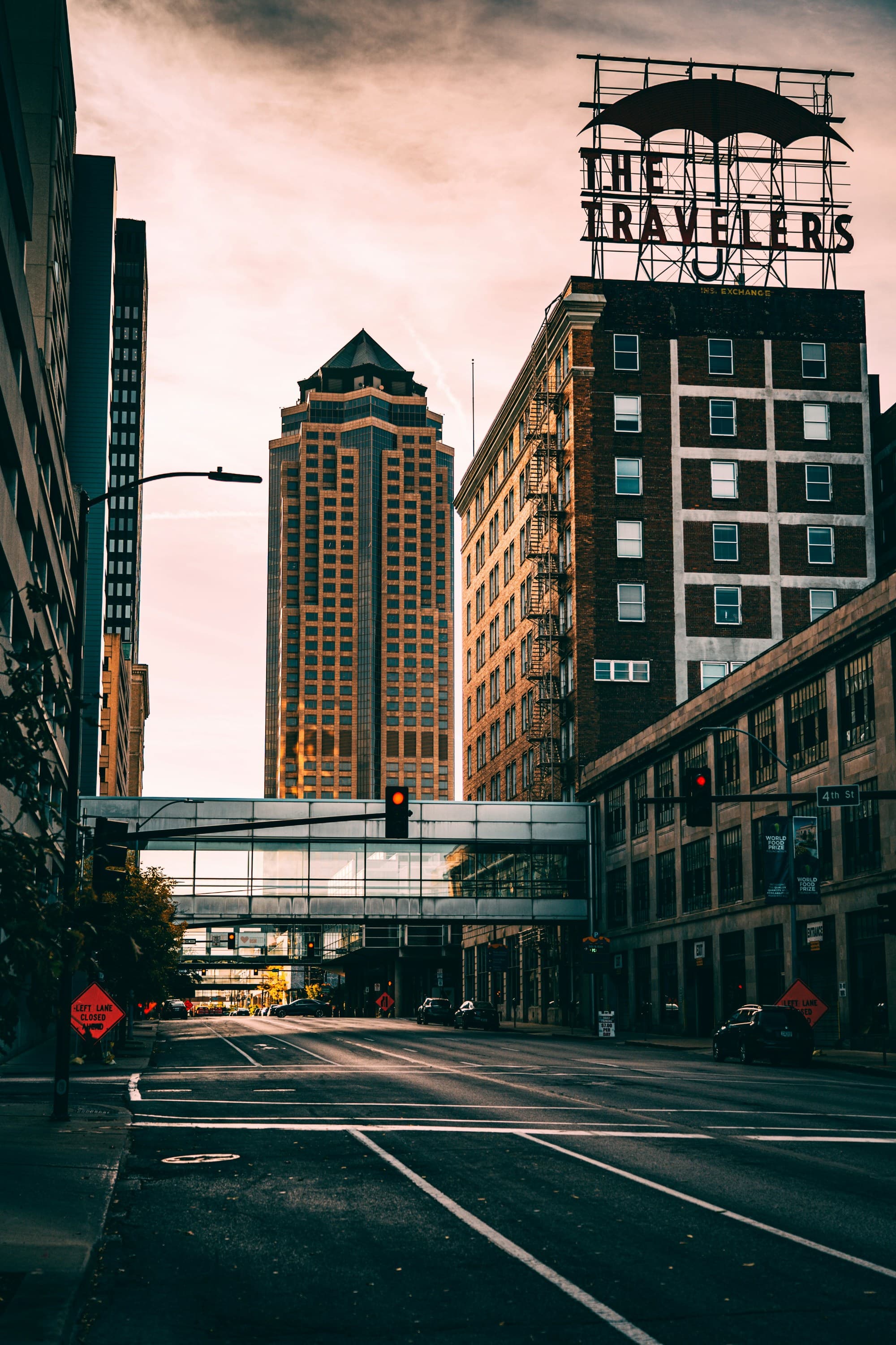 A city street intersection with tall buildings a view of skyscrapers at dusk