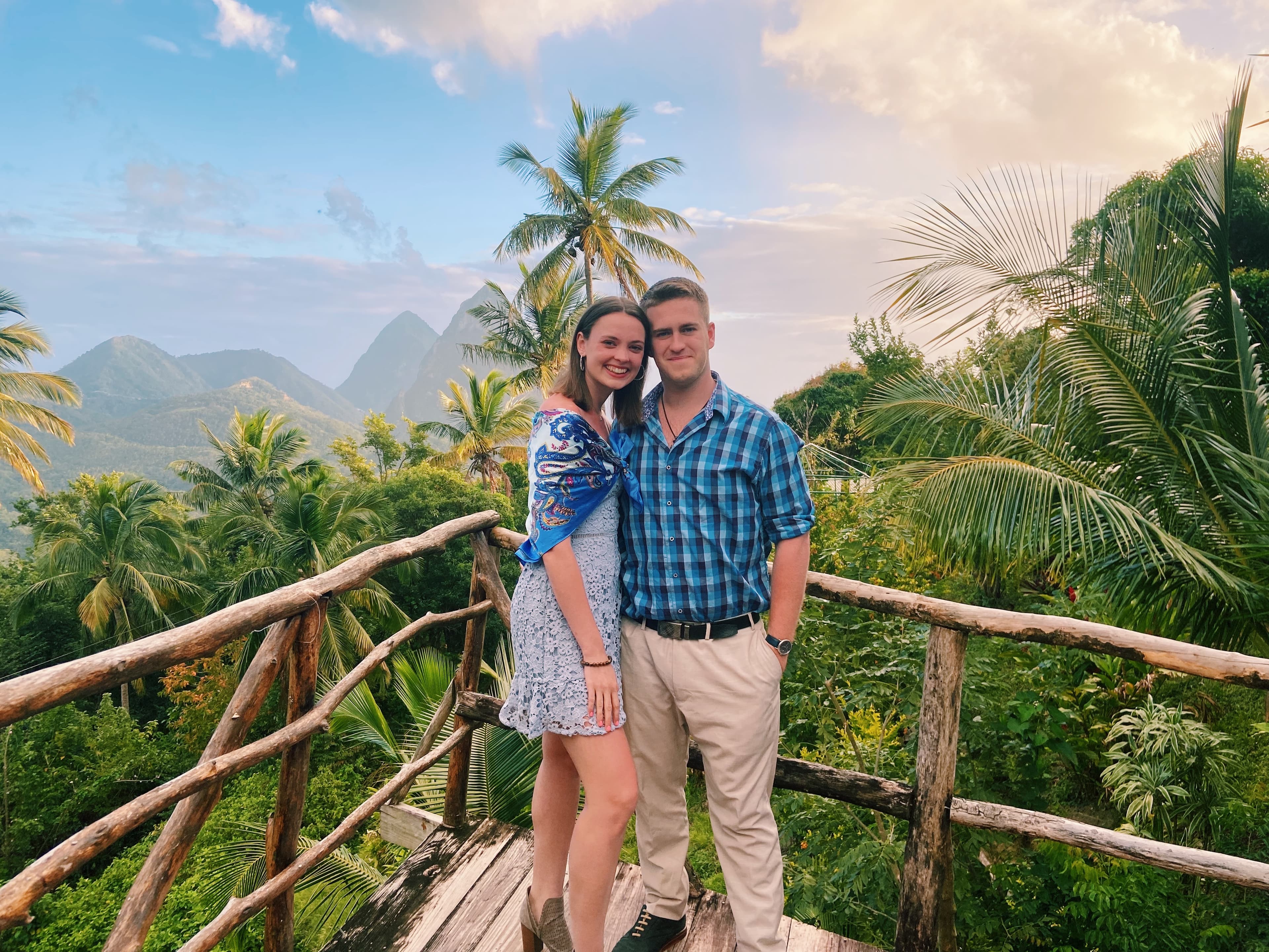 Tree top restaurant with a view of the Pitons in the distance and a lush jungle.