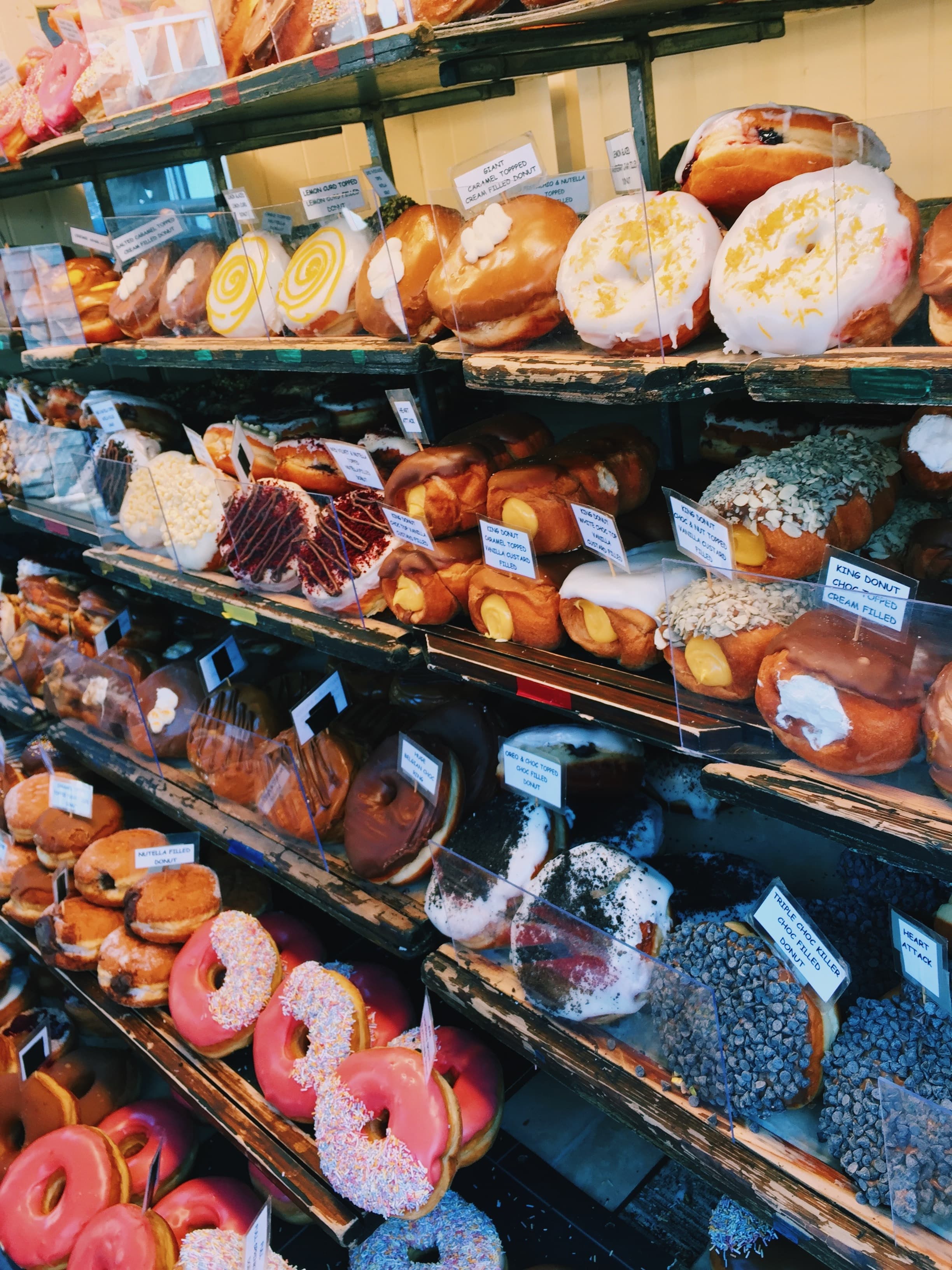 Pastries on shelves in a bakery.