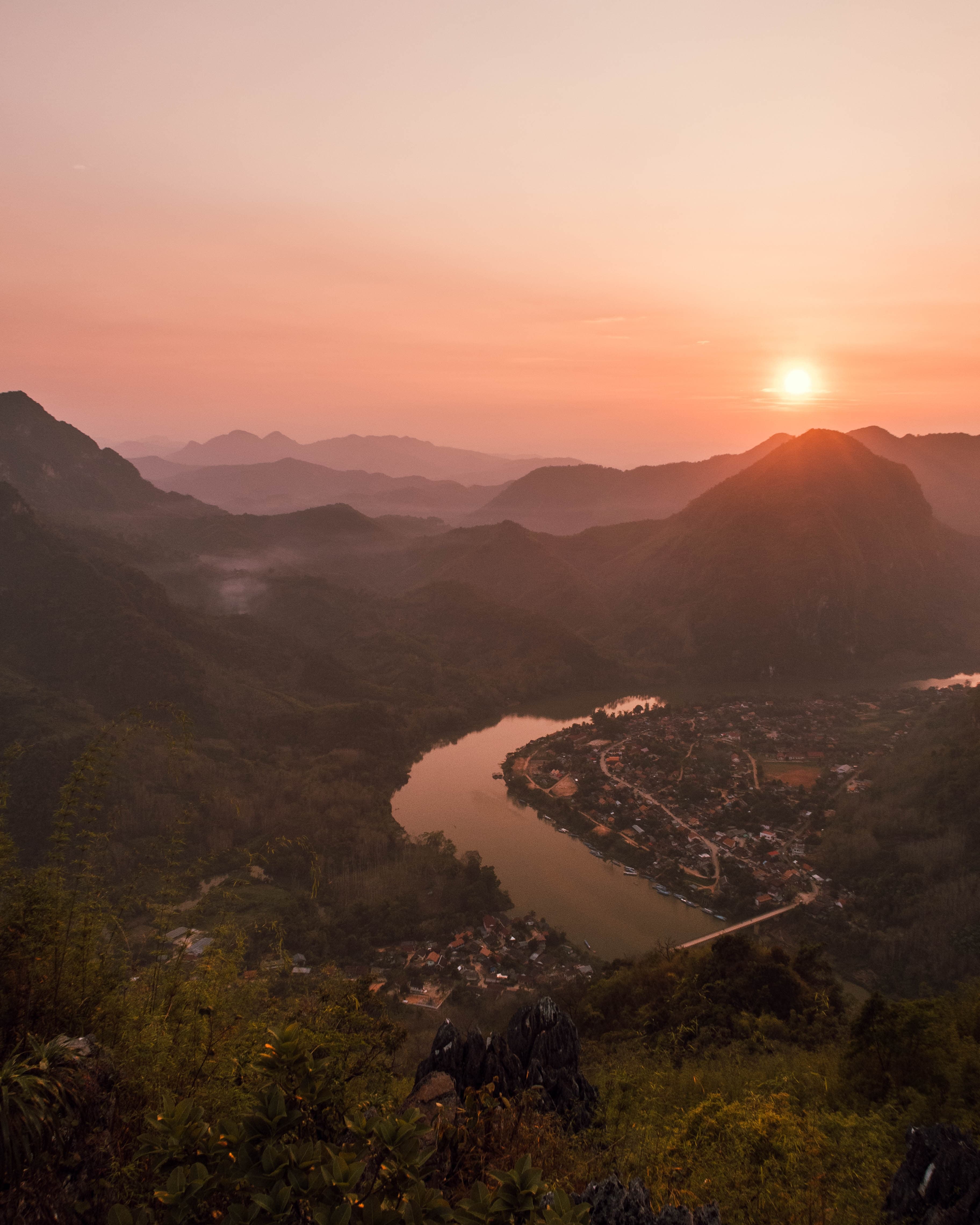 Sunset over the river and mountains in Laos.