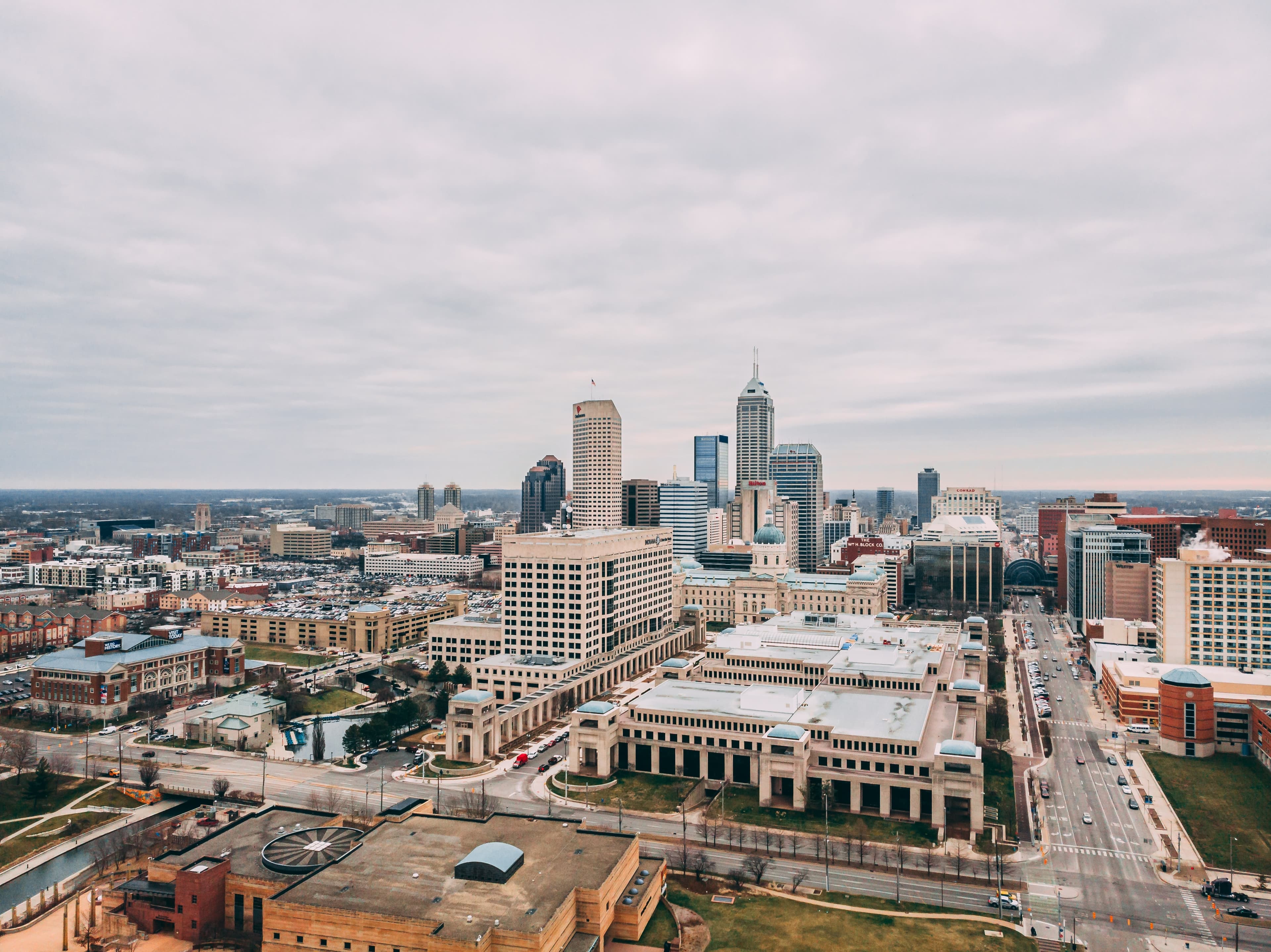 View of buildings and skyscrapers in downtown Indianapolis with a cloudy, grey sky
