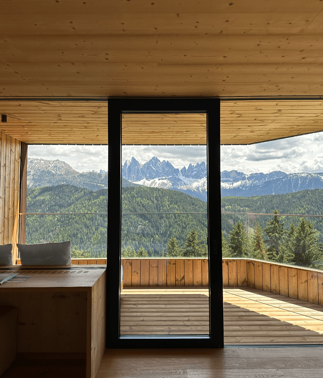 View from a room overlooking stunning patio forest landscapes on a sunny day.