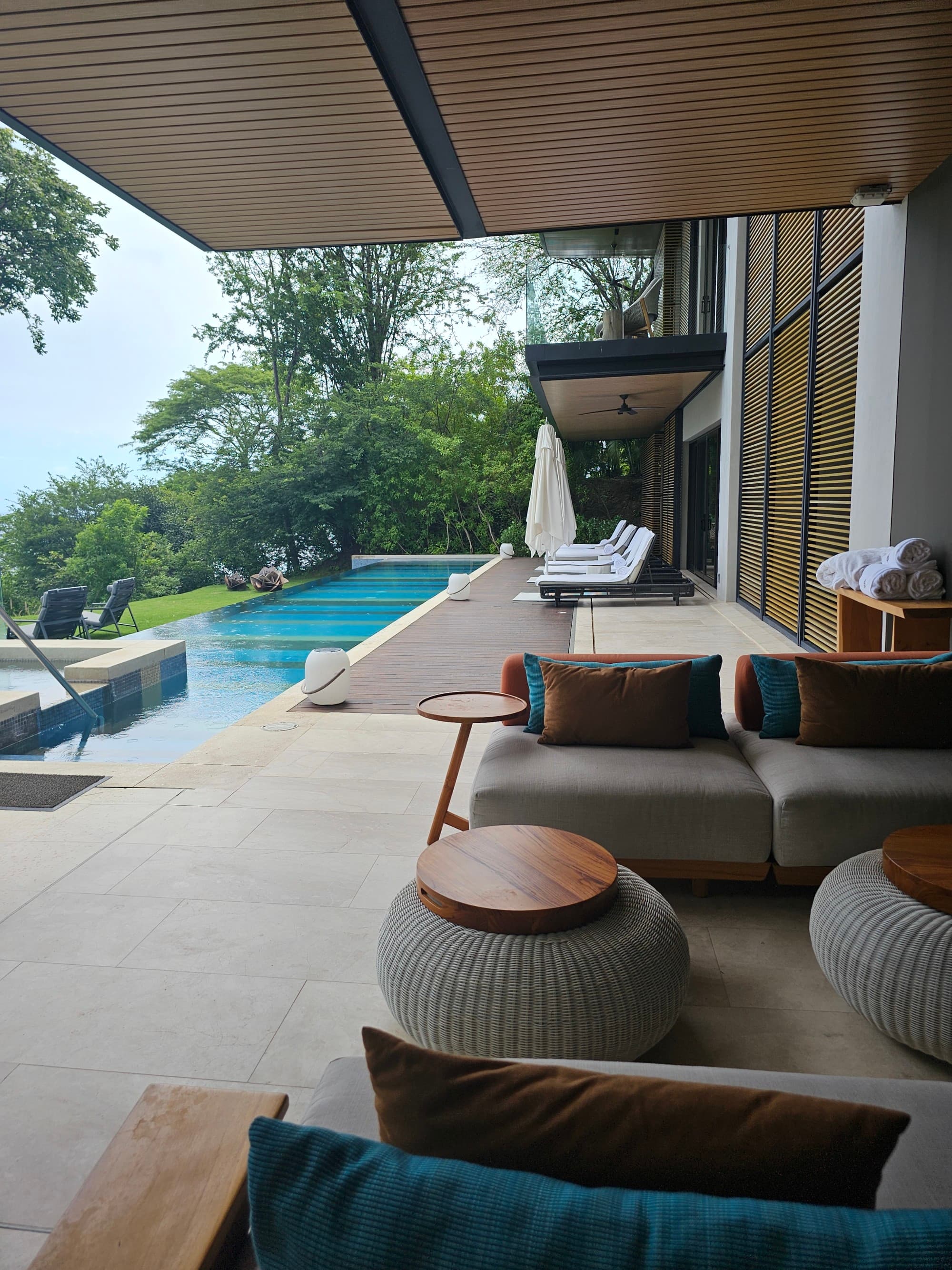An open-air hotel balcony with an adjoining swimming pool