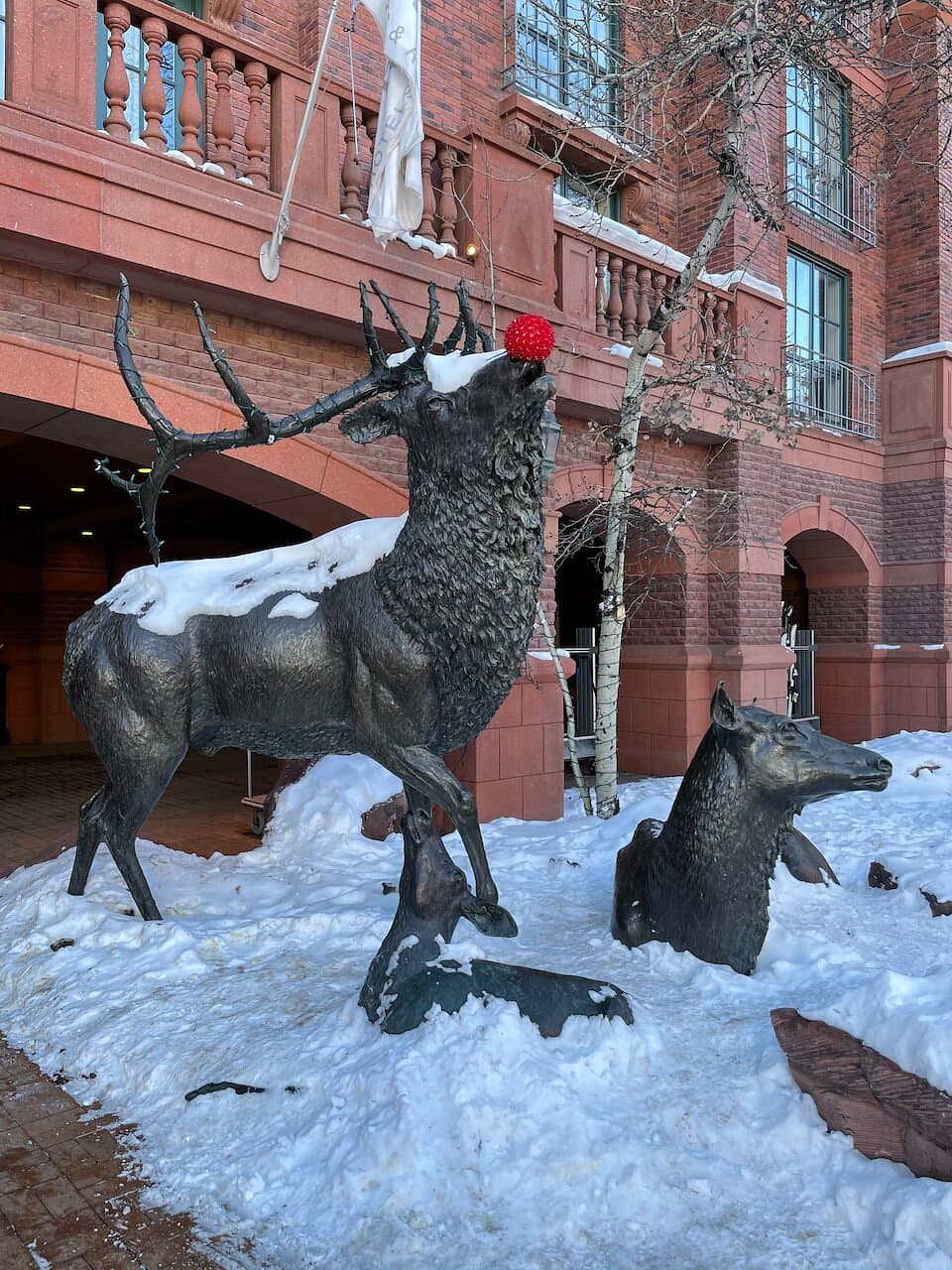 St. Regis Hotel bronzed reindeer statue outside the hotel wears a red Rudolph nose for the holidays.