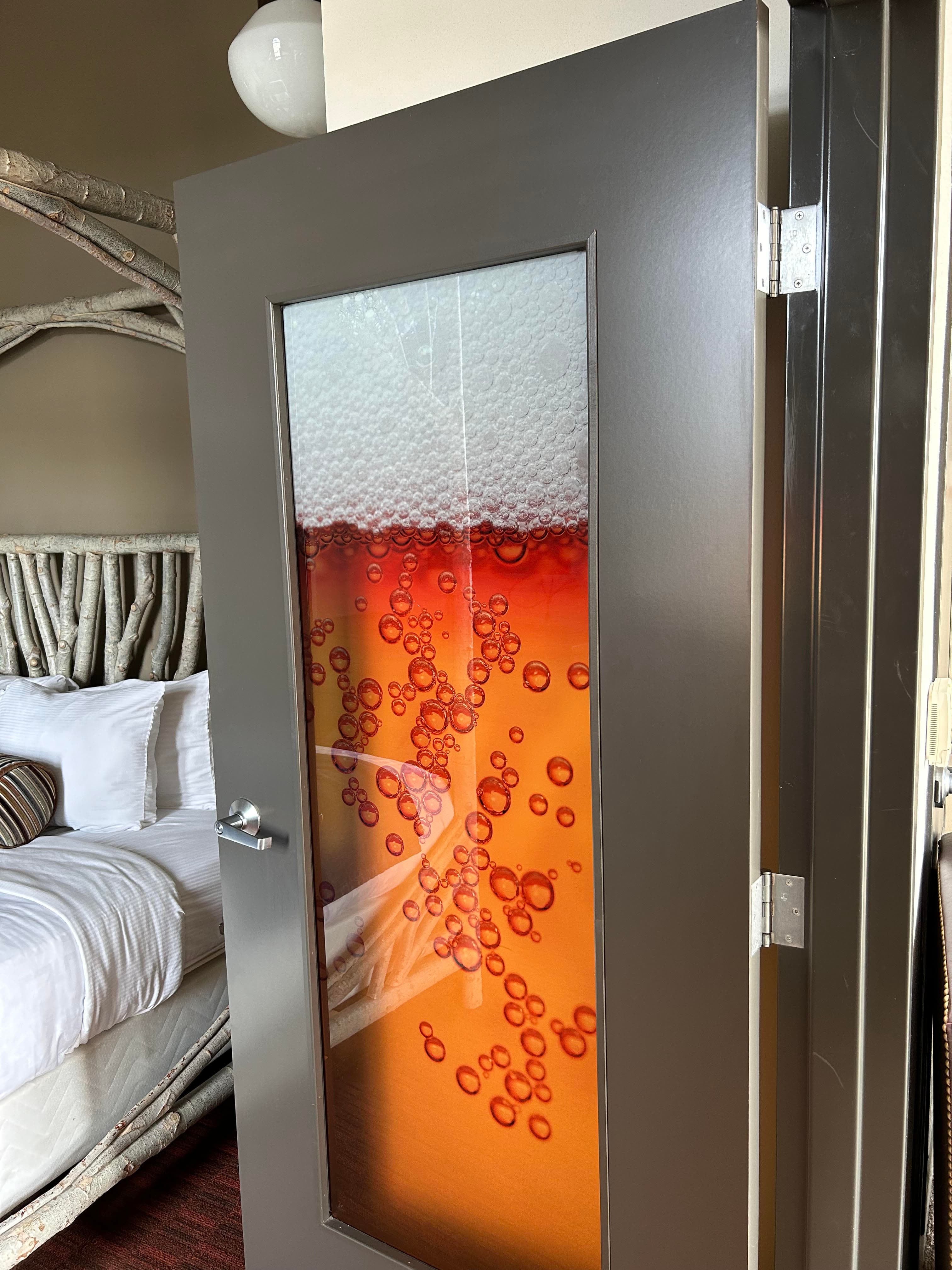 Stained glass window depicting historical figure in green and purples on a sunny day.