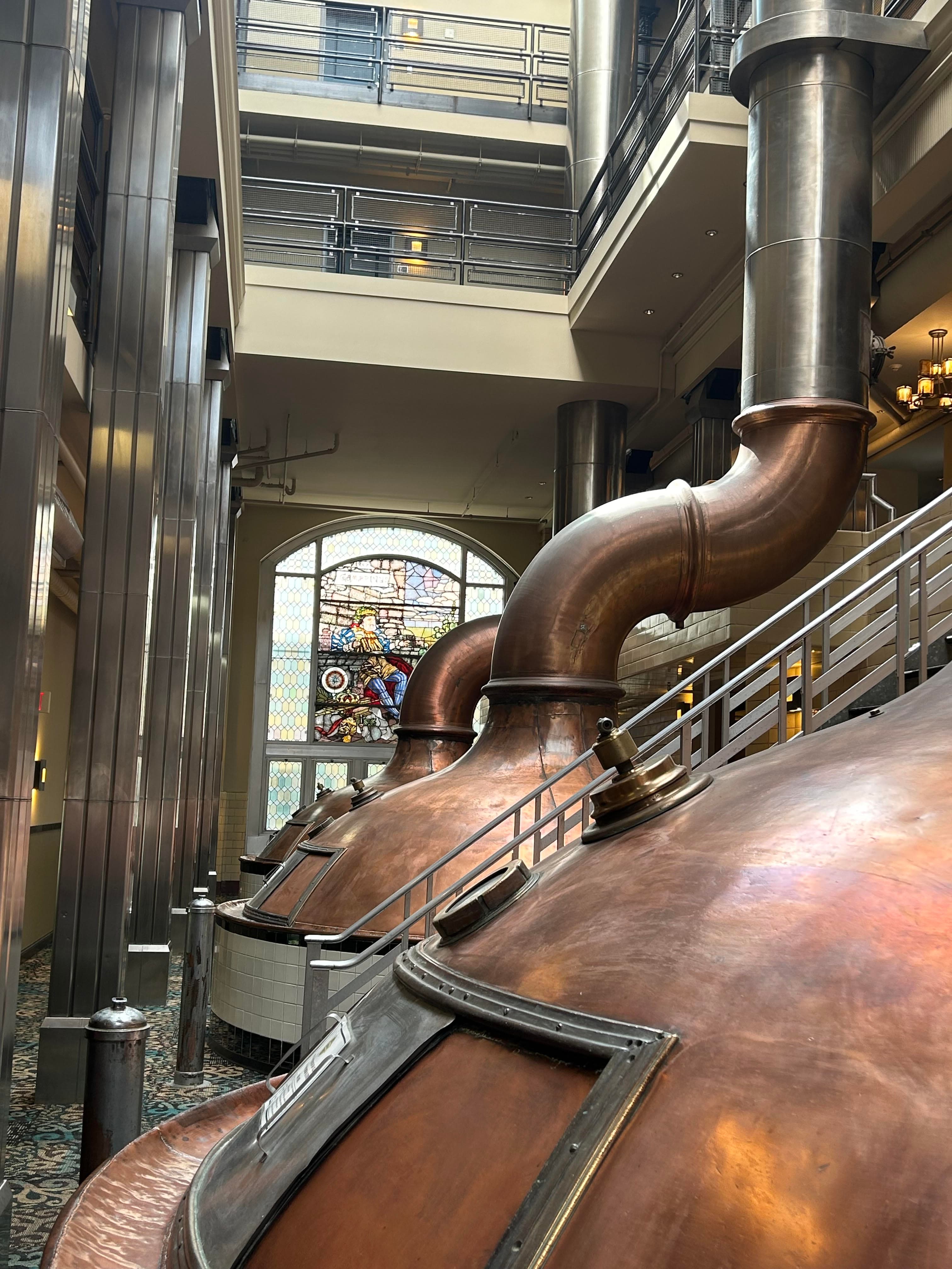 Room of brewhouse with brick walls and modern amenities.