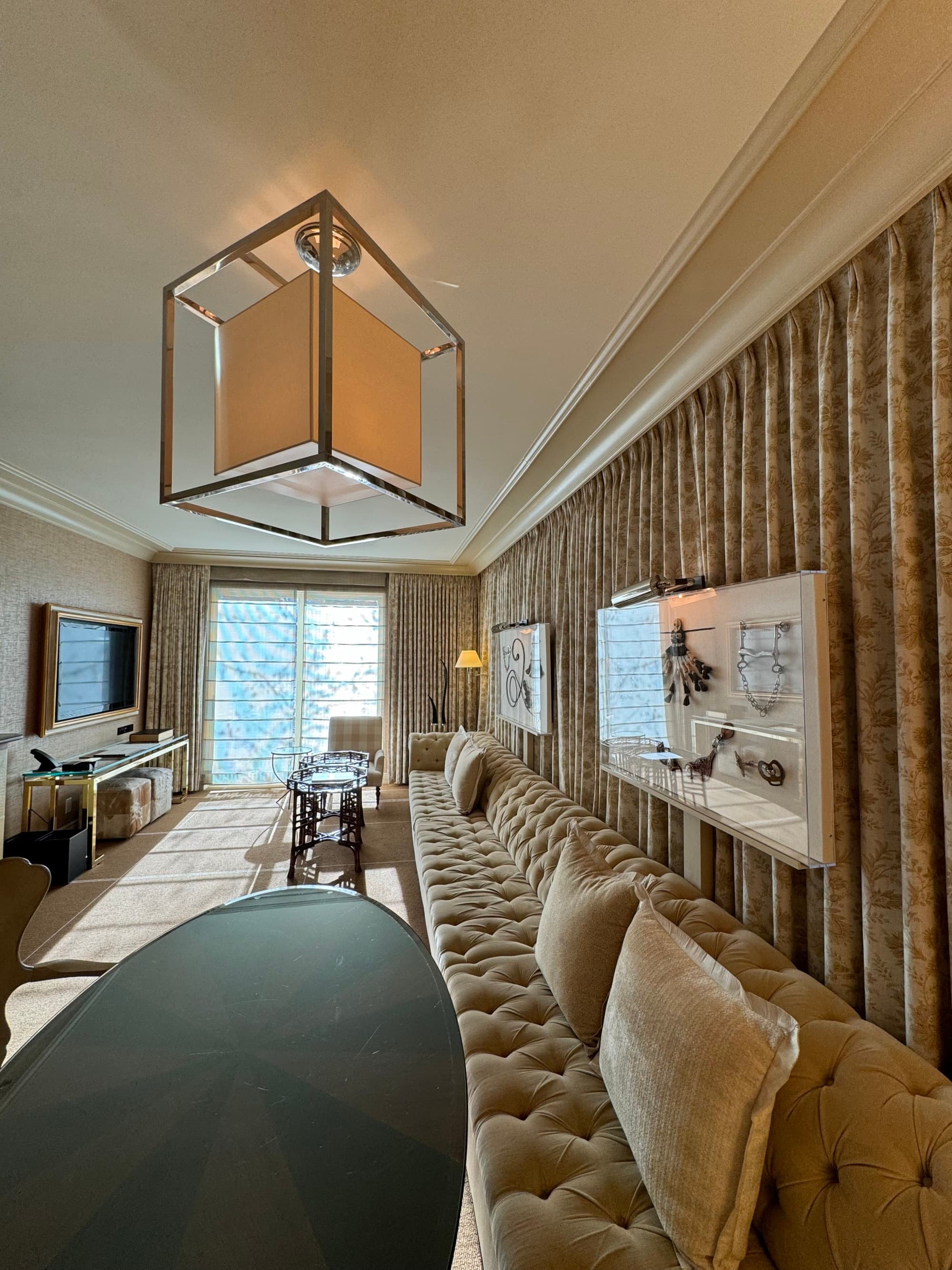 A grand sitting area, with an extensive sofa, curtains, tables, and Americana decor.