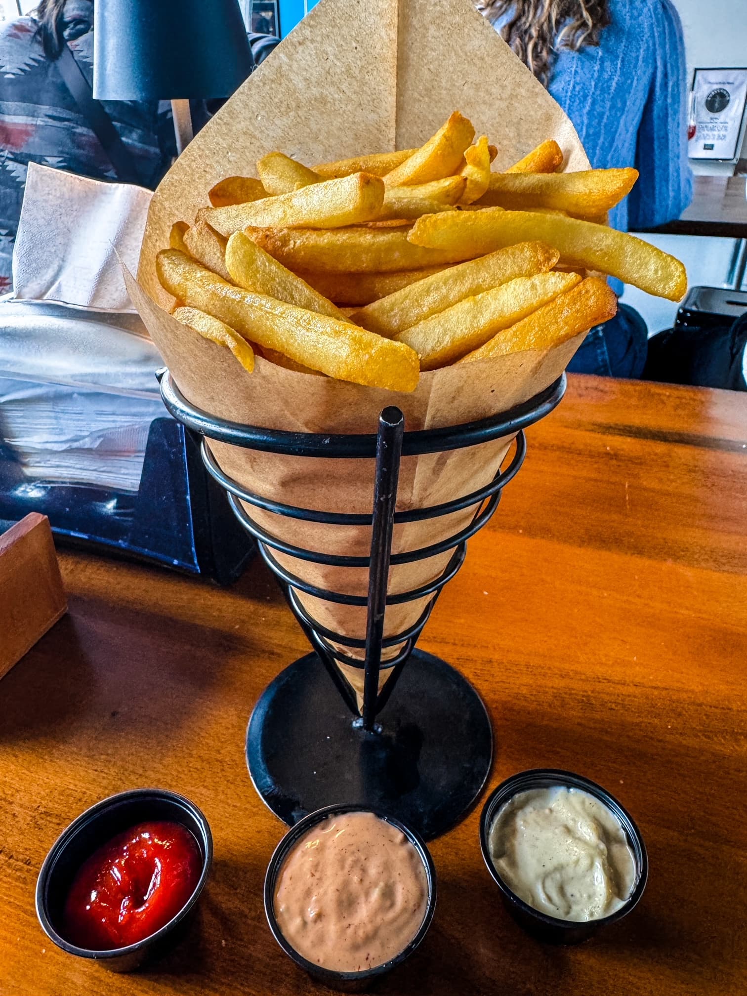 Golden-brown fries and three dipping sauces at Subversive Brewing.