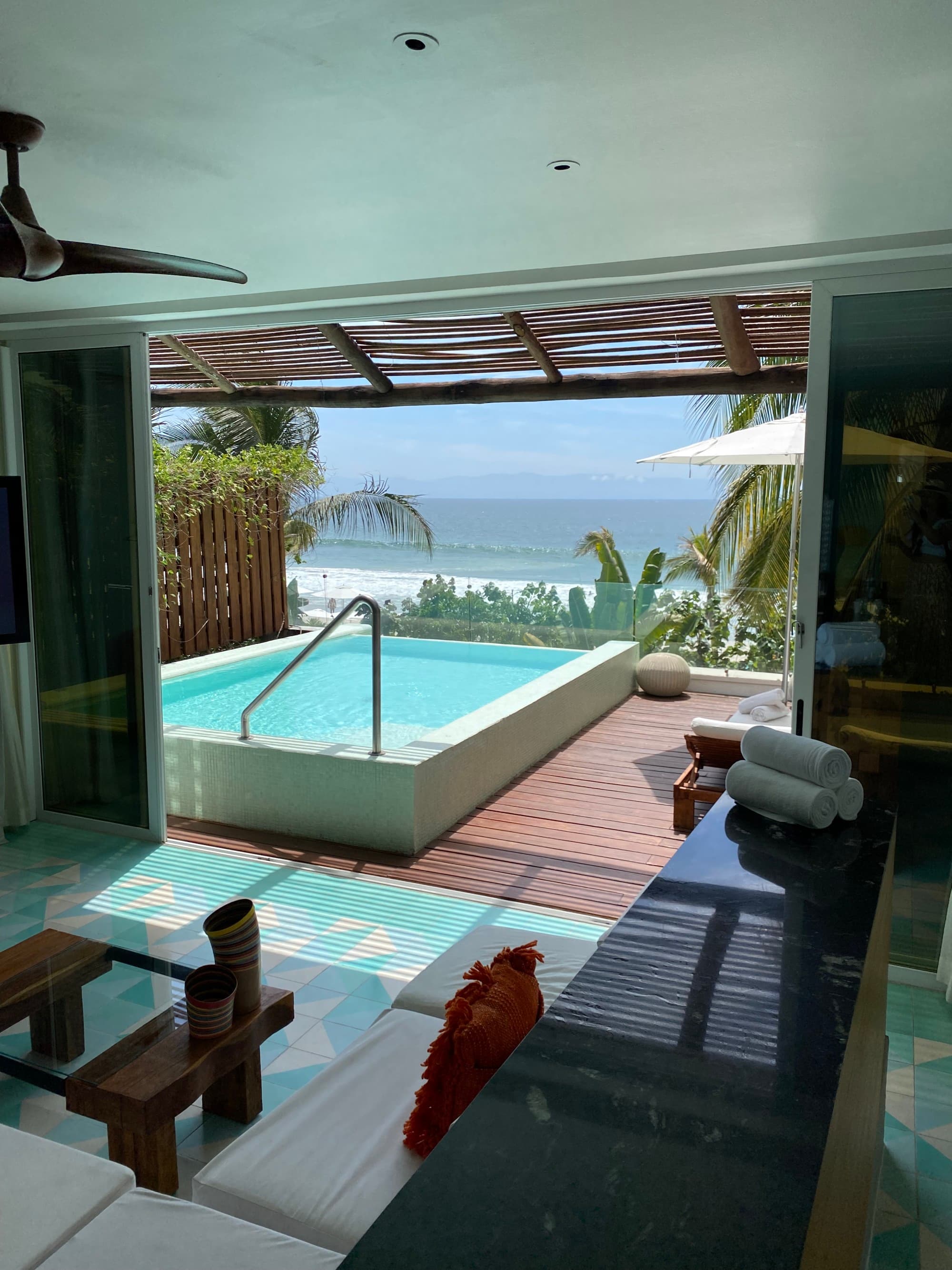 A hotel room balcony with a hot tub