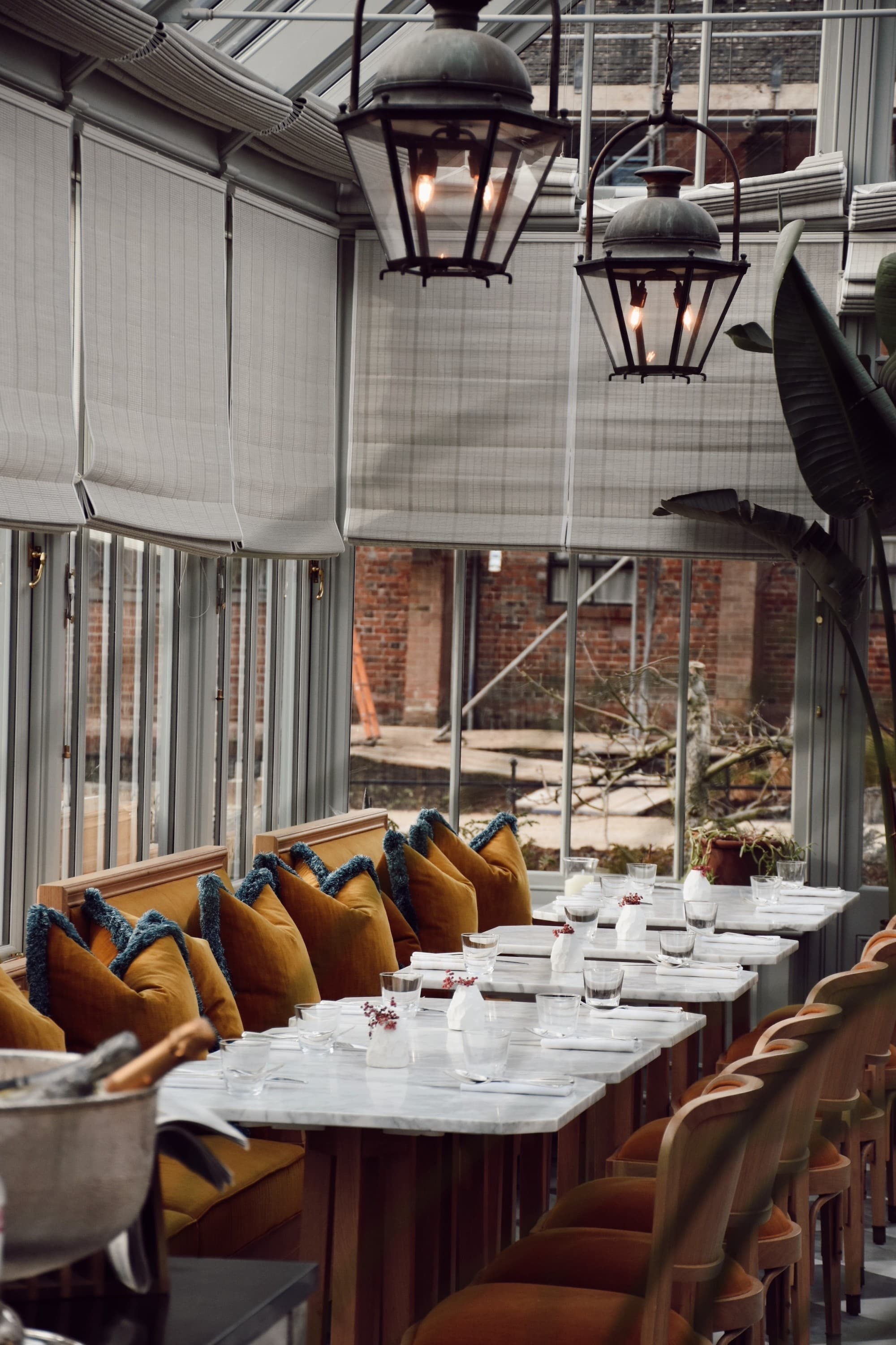 A dining area in a room with tall windows