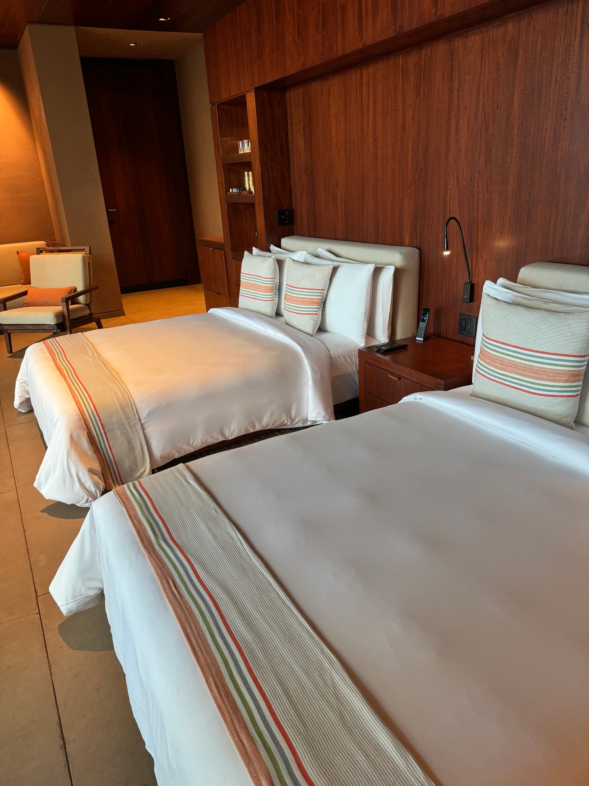 Two white beds in a hotel room