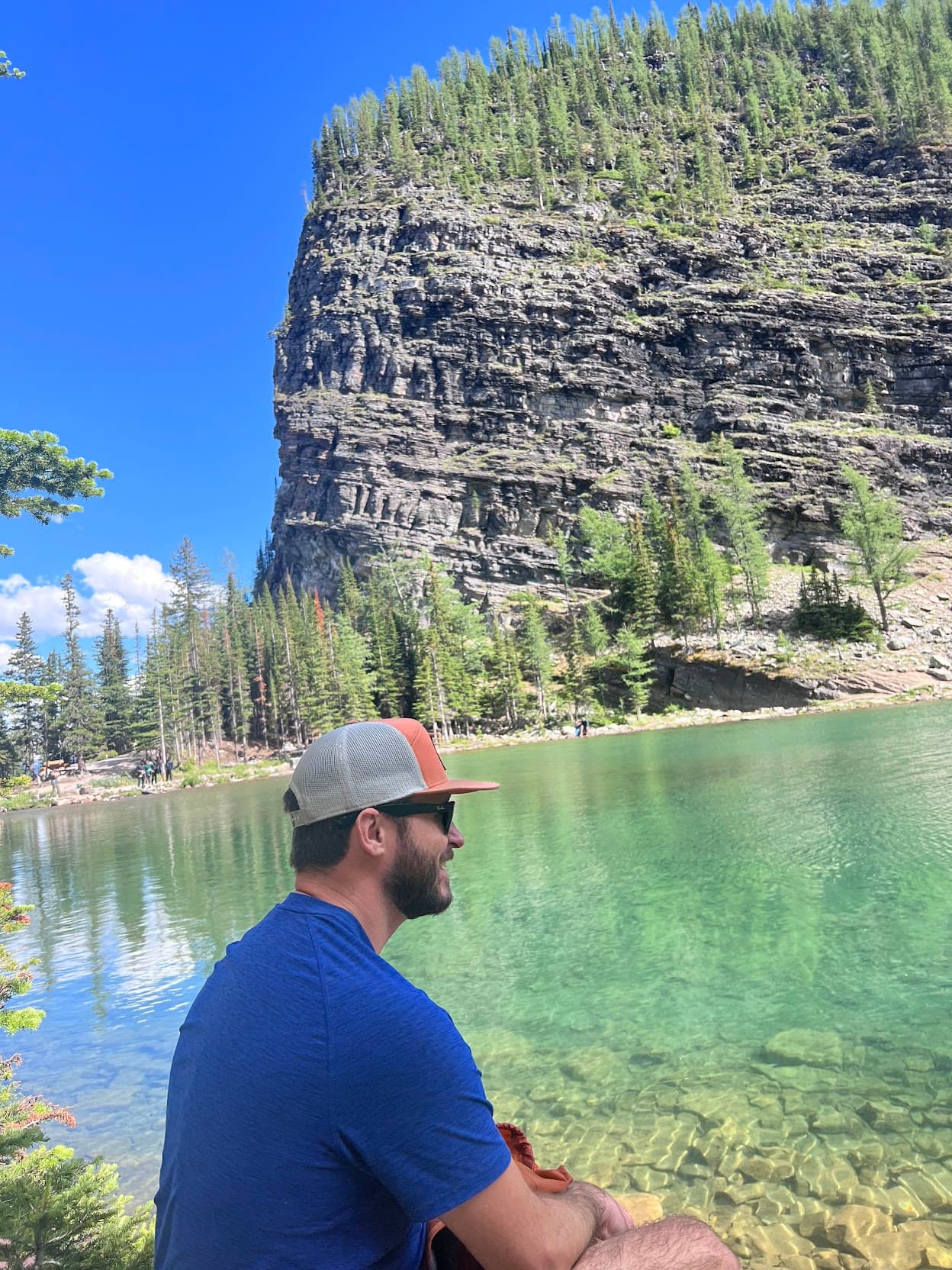Man posing beside a lake
