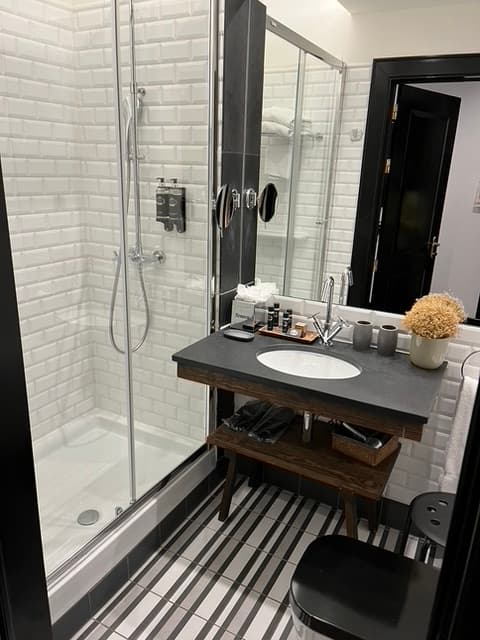 a white-tiled bathroom shower