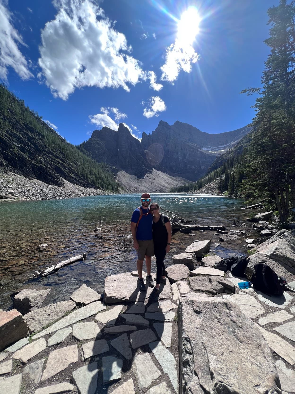 couple posing beside lake