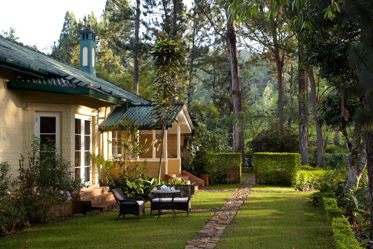 a charming yellow cottage in a lush courtyard