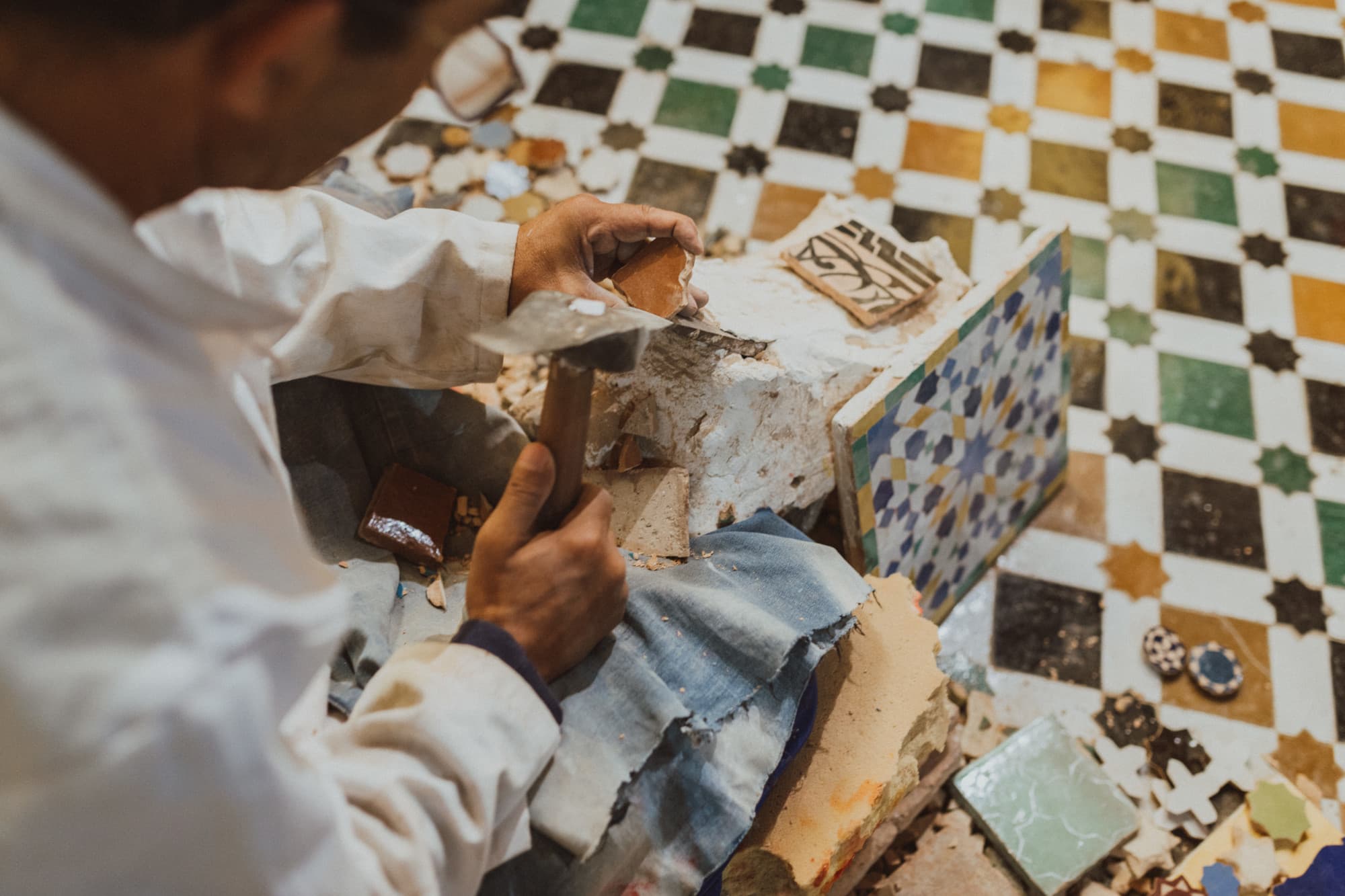 a man holds colorful tiles