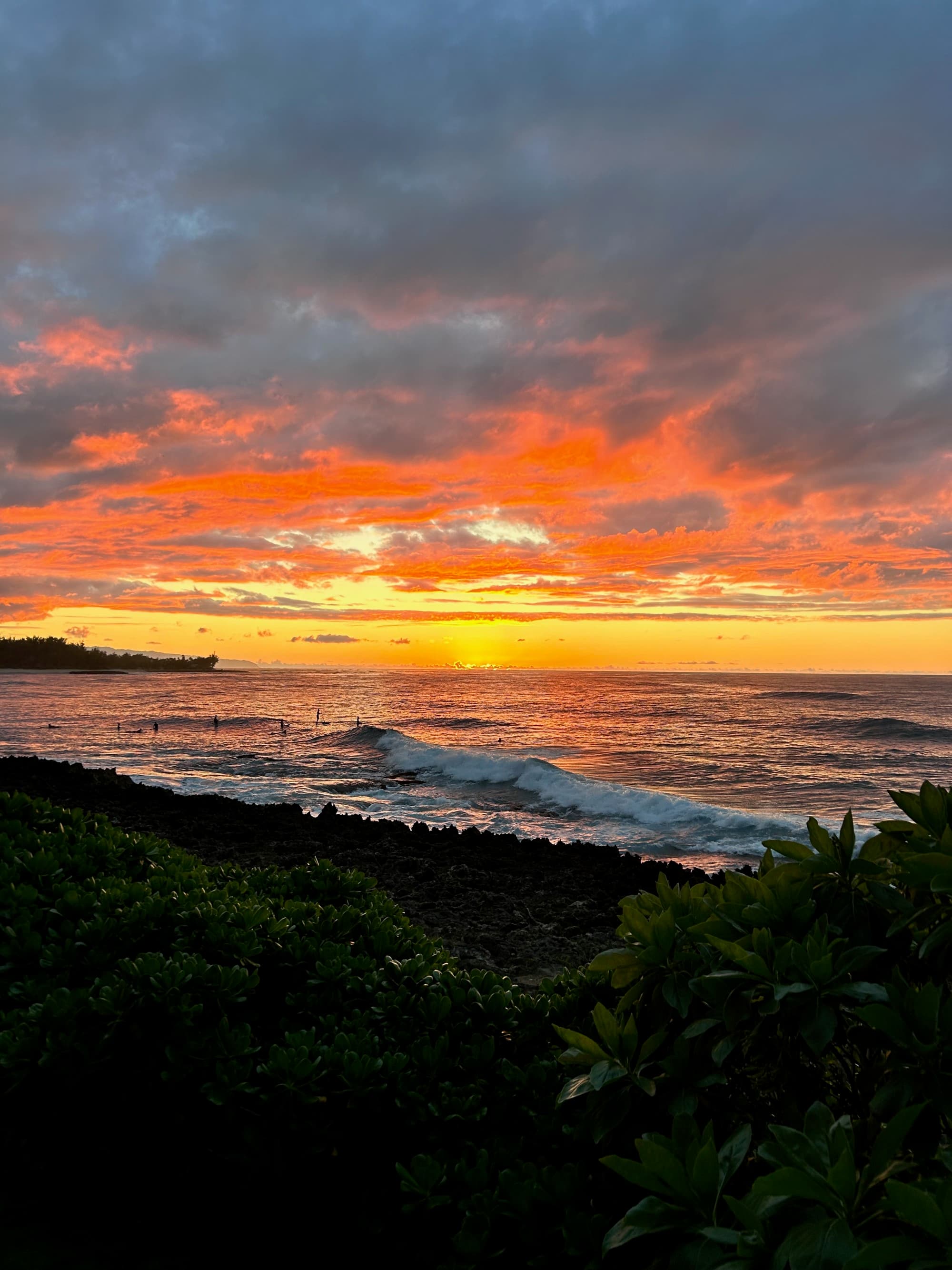 A sunset over the water next to the beach