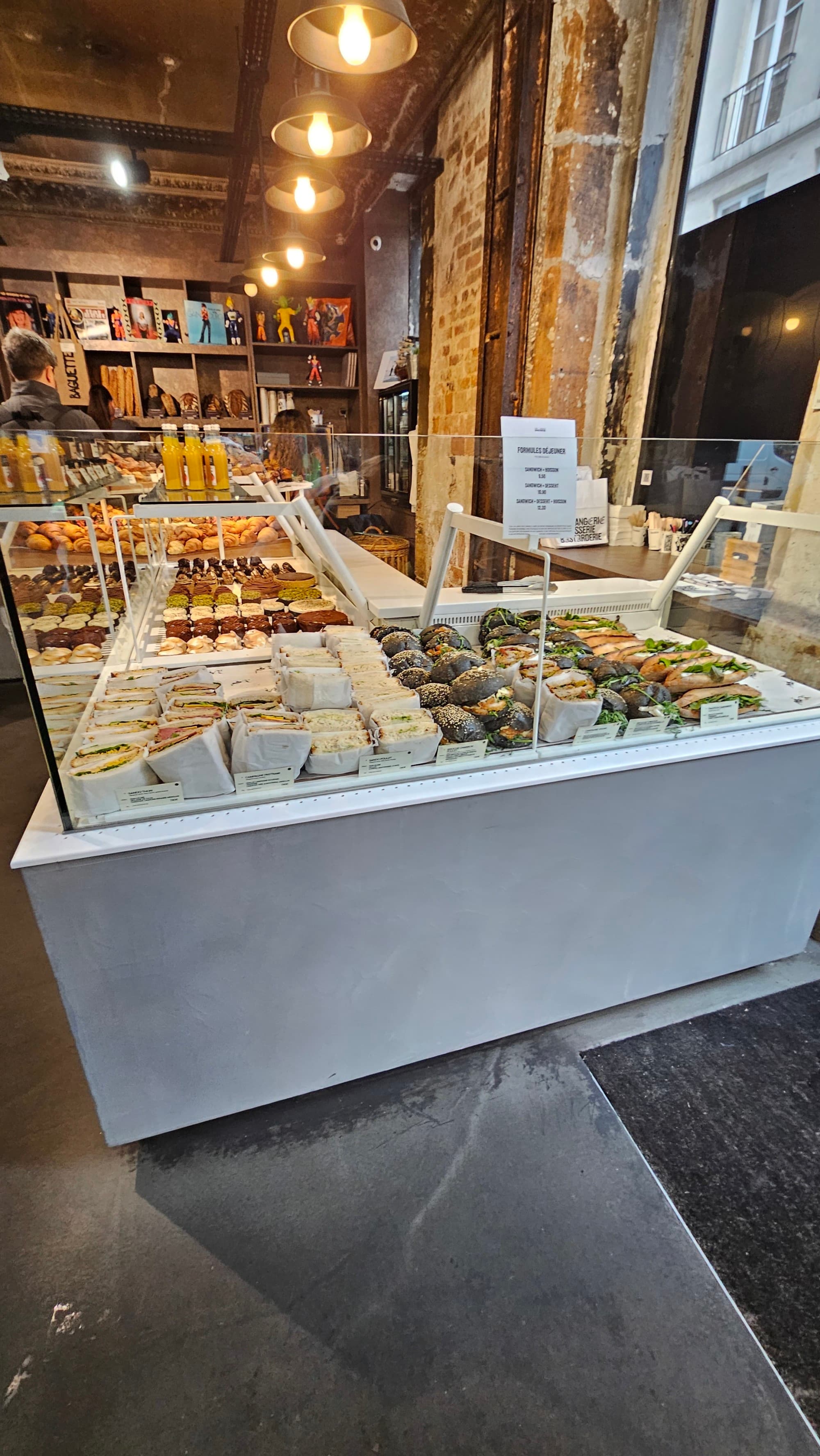 A display case in a bakery inside of an industrial-chic building in one of the best shopping areas in Paris.