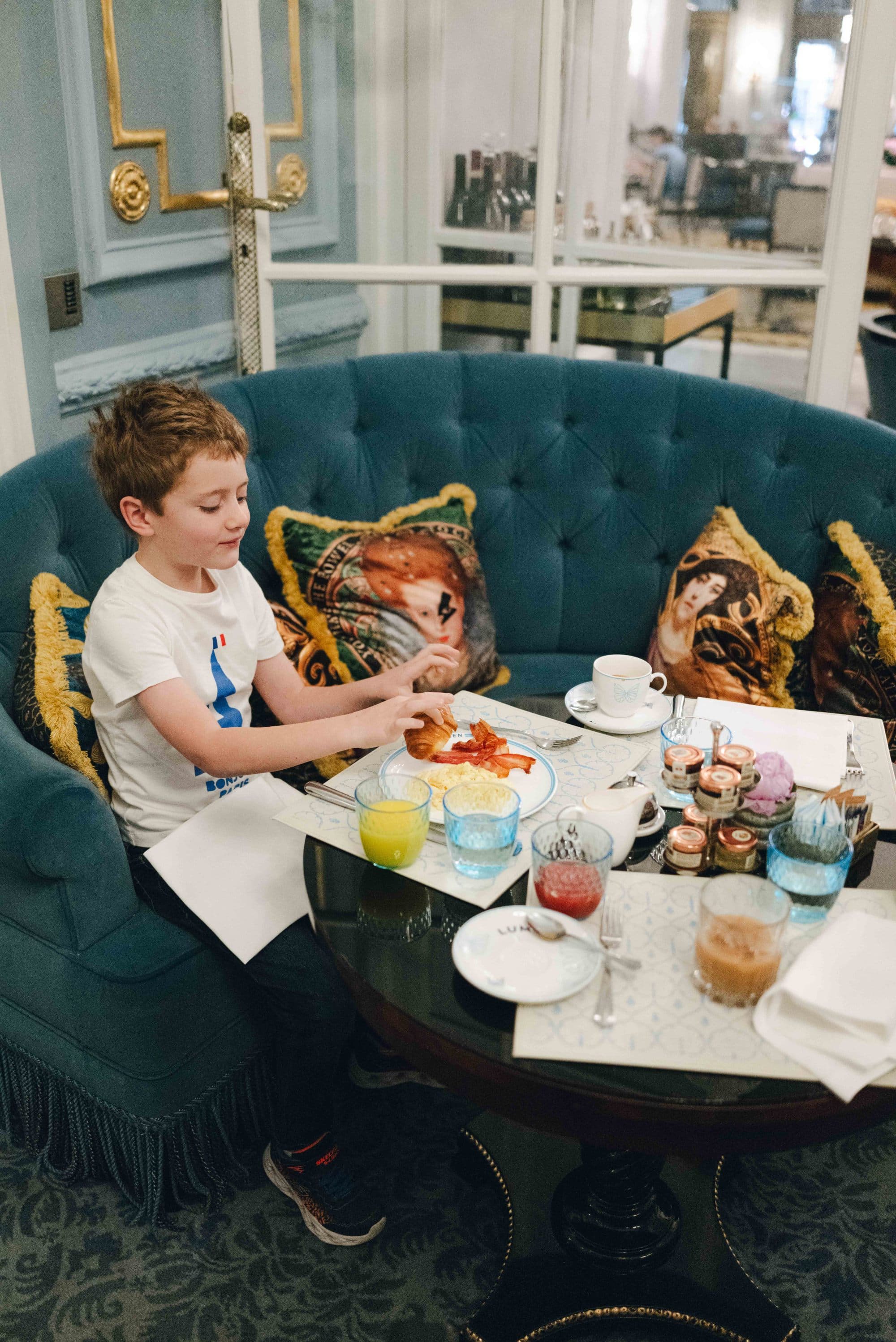 A child sitting at a table with food