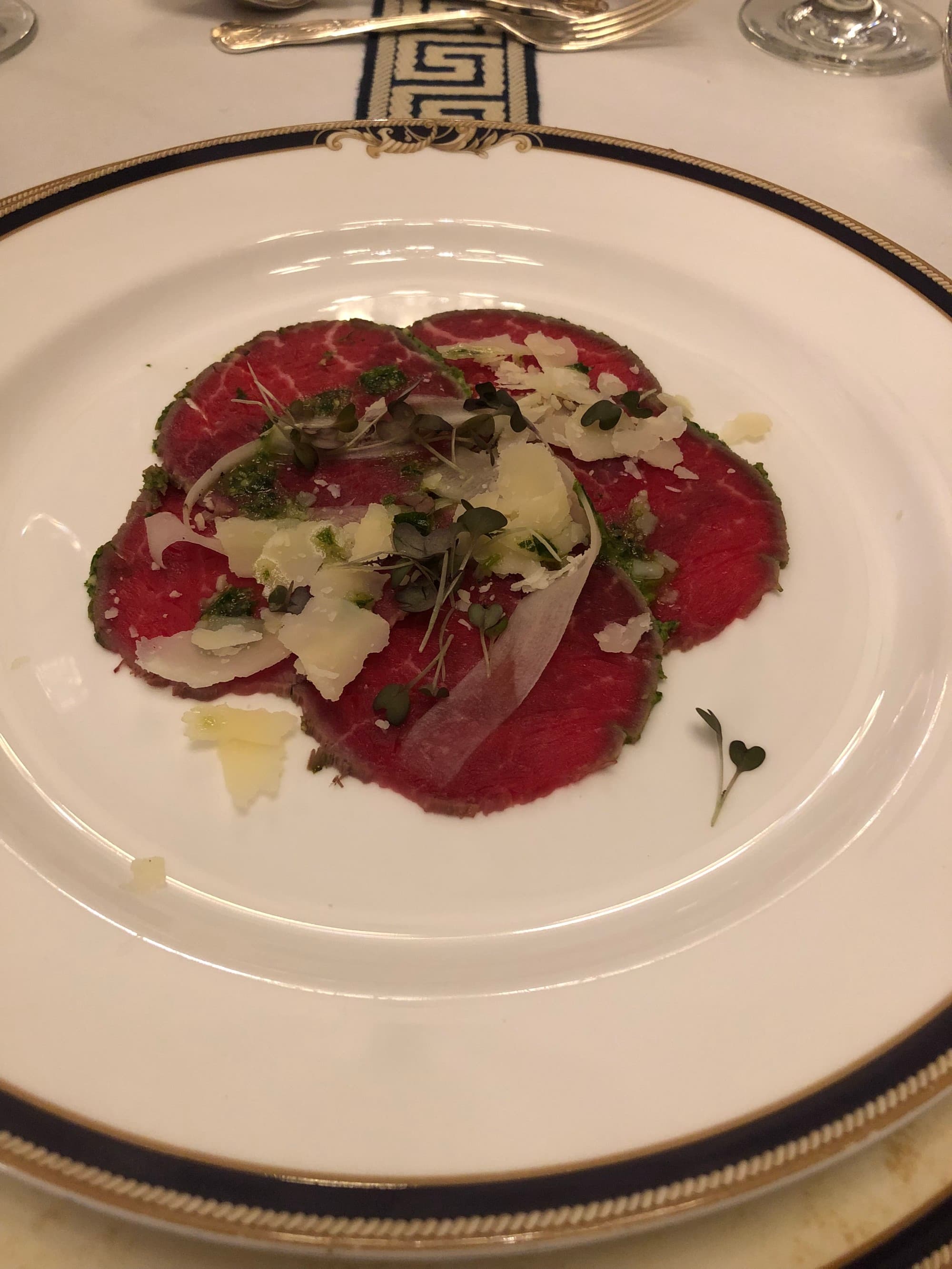 An aerial view of a white plate with food at a restaurant
