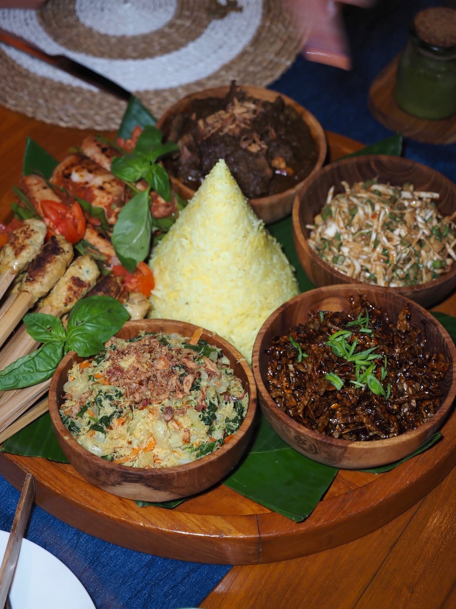 Bowls on a plate full of various types of food