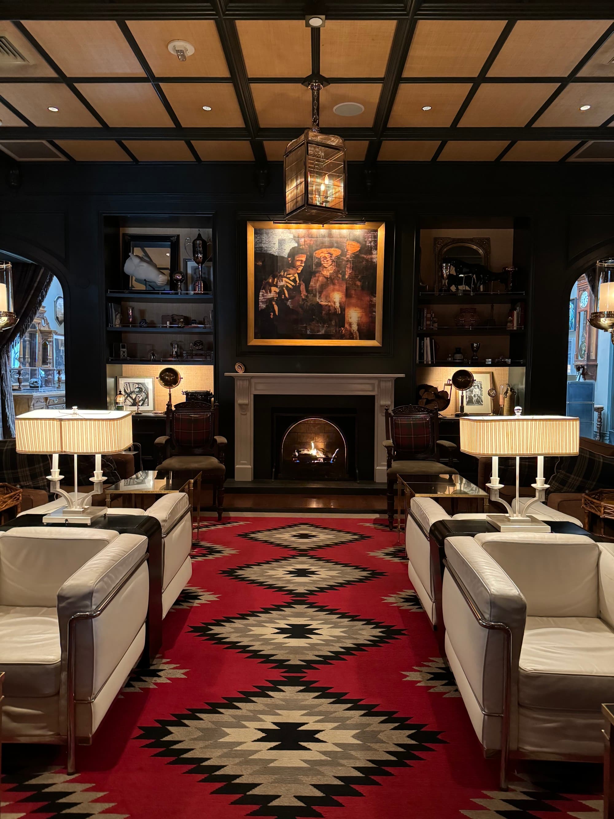Inside the hotel's lounge area, with a fire place, comfy furniture and Western Americana style decor.