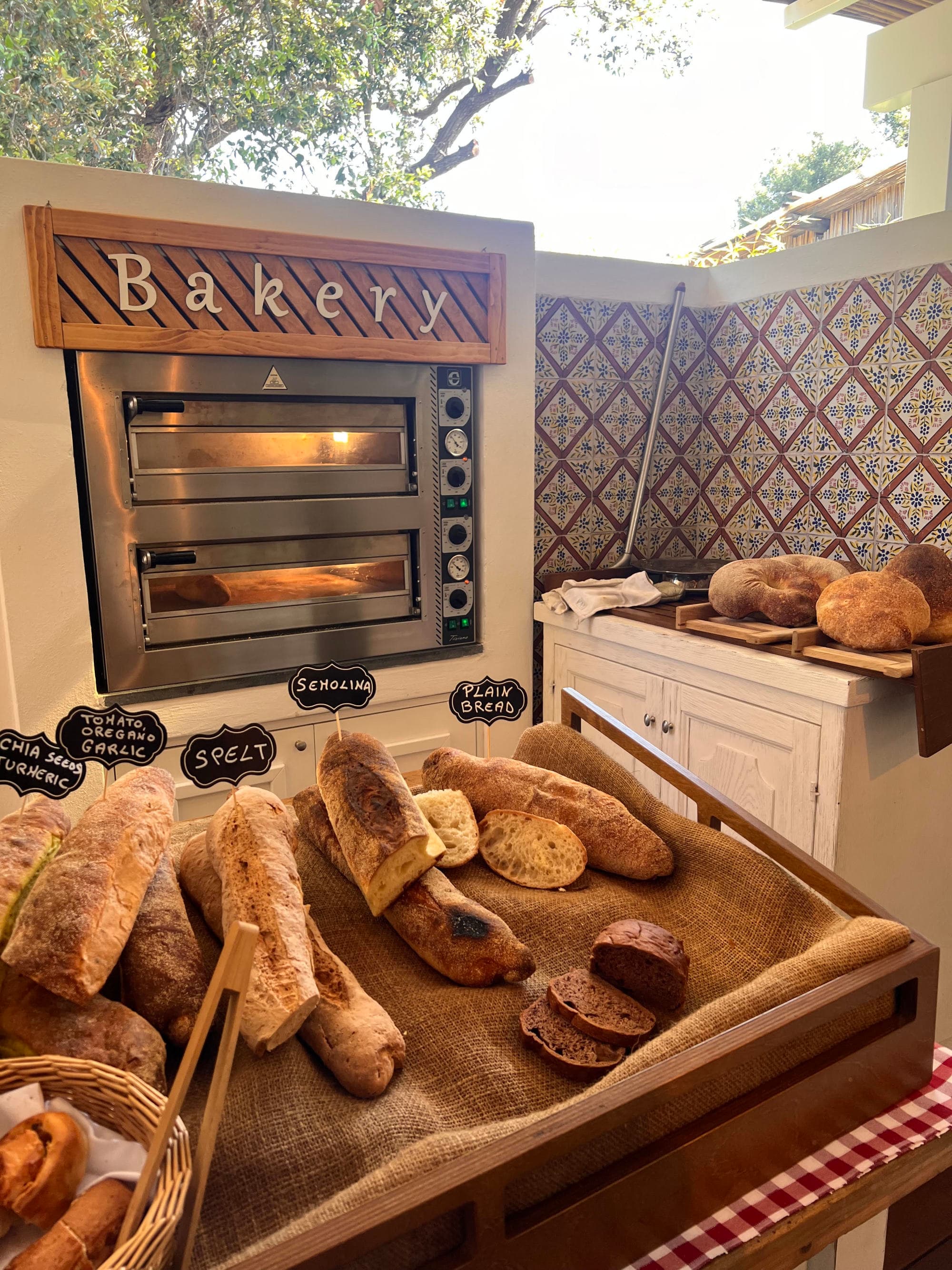 A table full of fresh bread at a bakery.