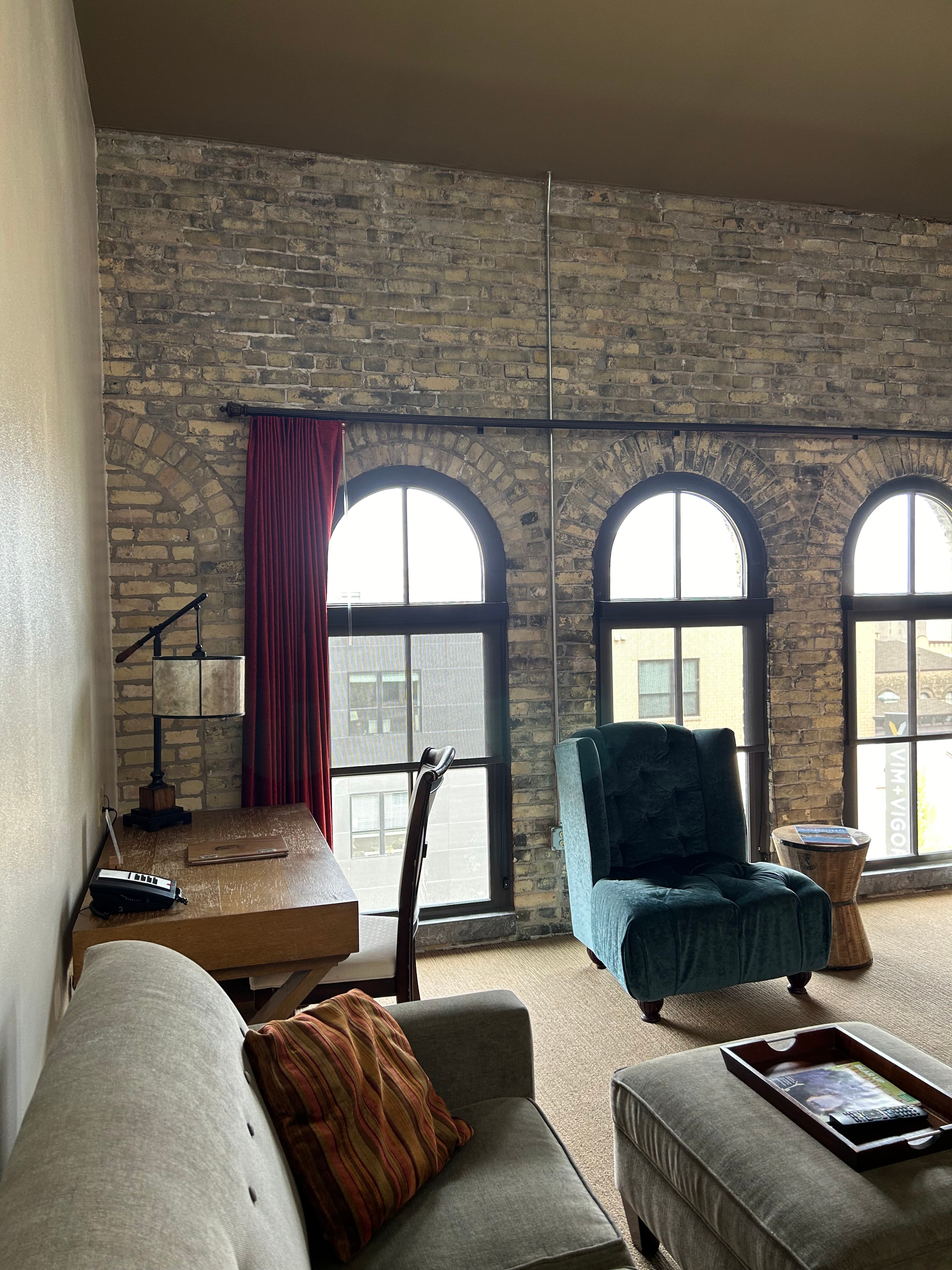 Original Pabst Brewery brewing kettles inside a large building with multiple railings above.