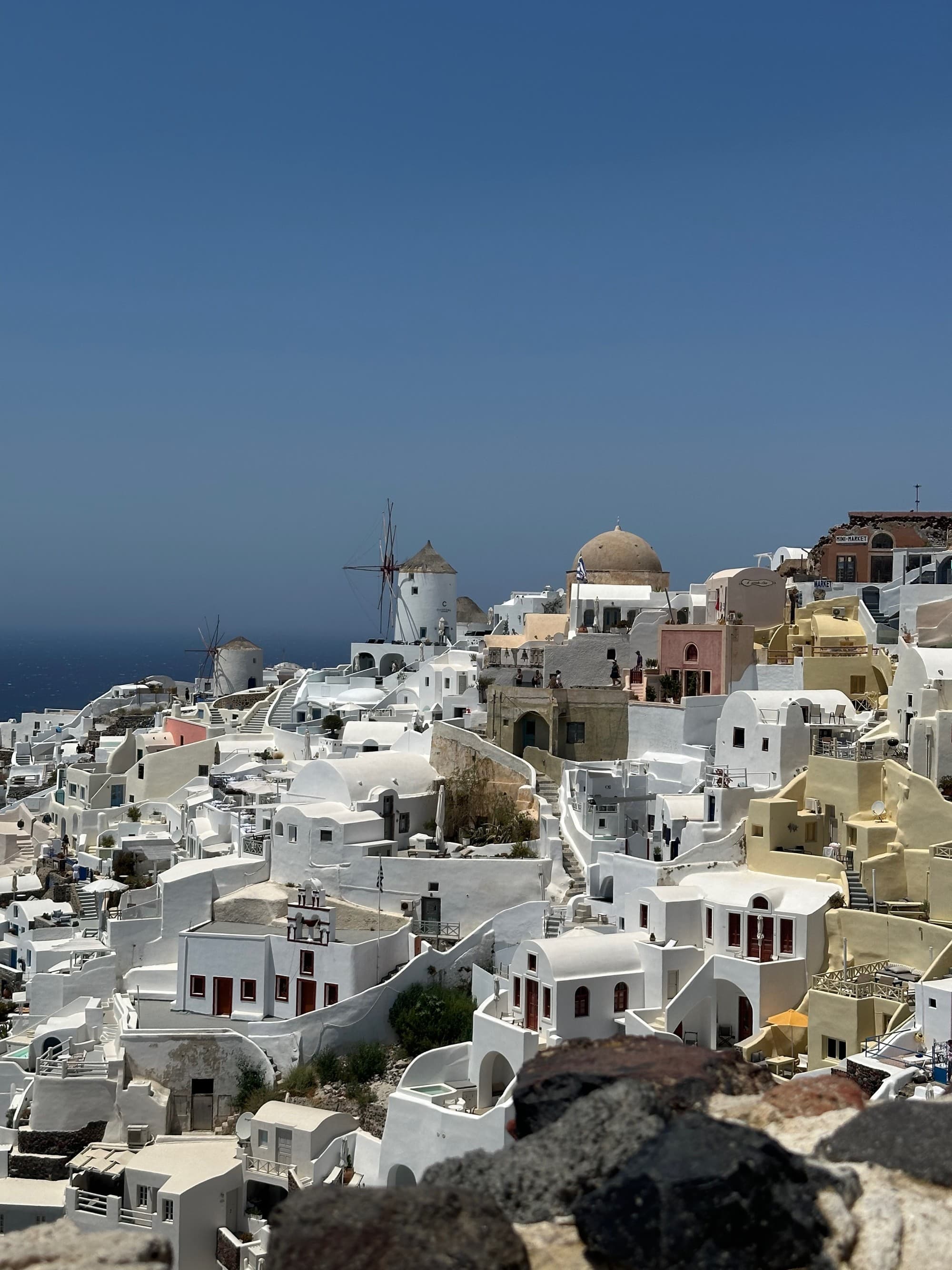 Iconic white buildings on a hillside in Santorini - Kristyne Wada