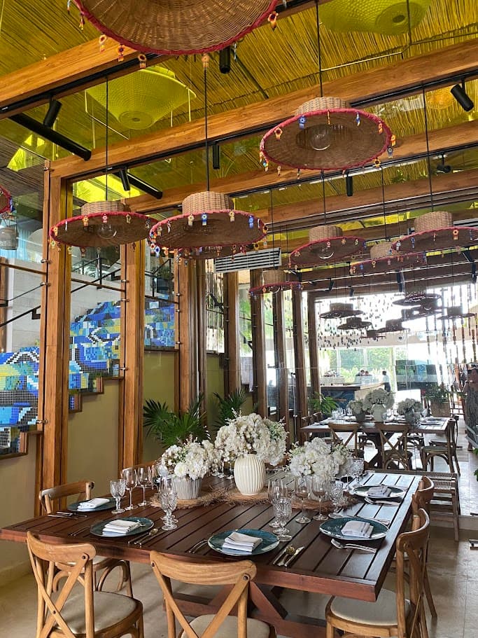 An outdoor restaurant dining area under a cover