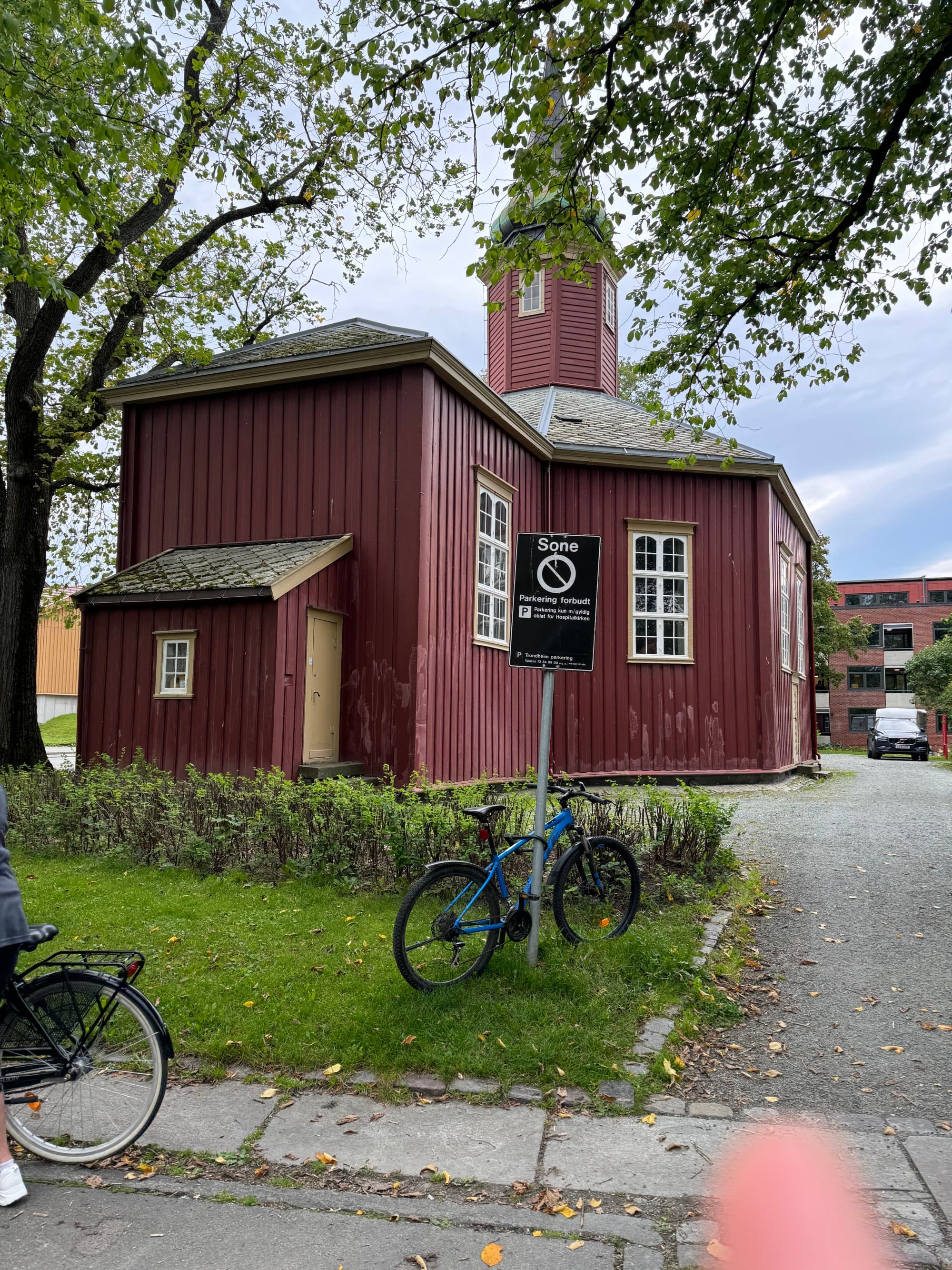 A red house with a patch of grass in the front