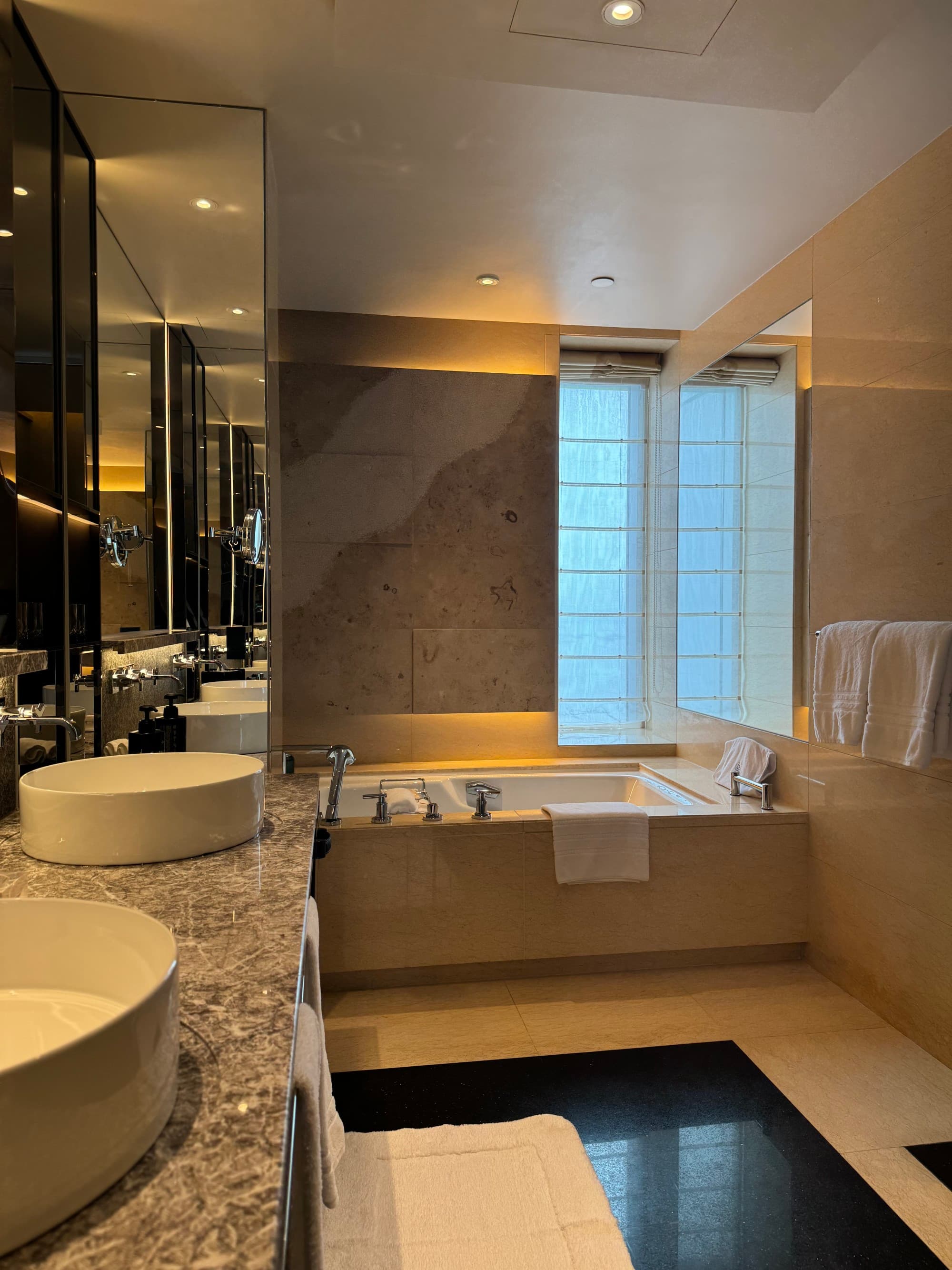 The spa-like, marble-clad bathroom was gigantic and luxurious.