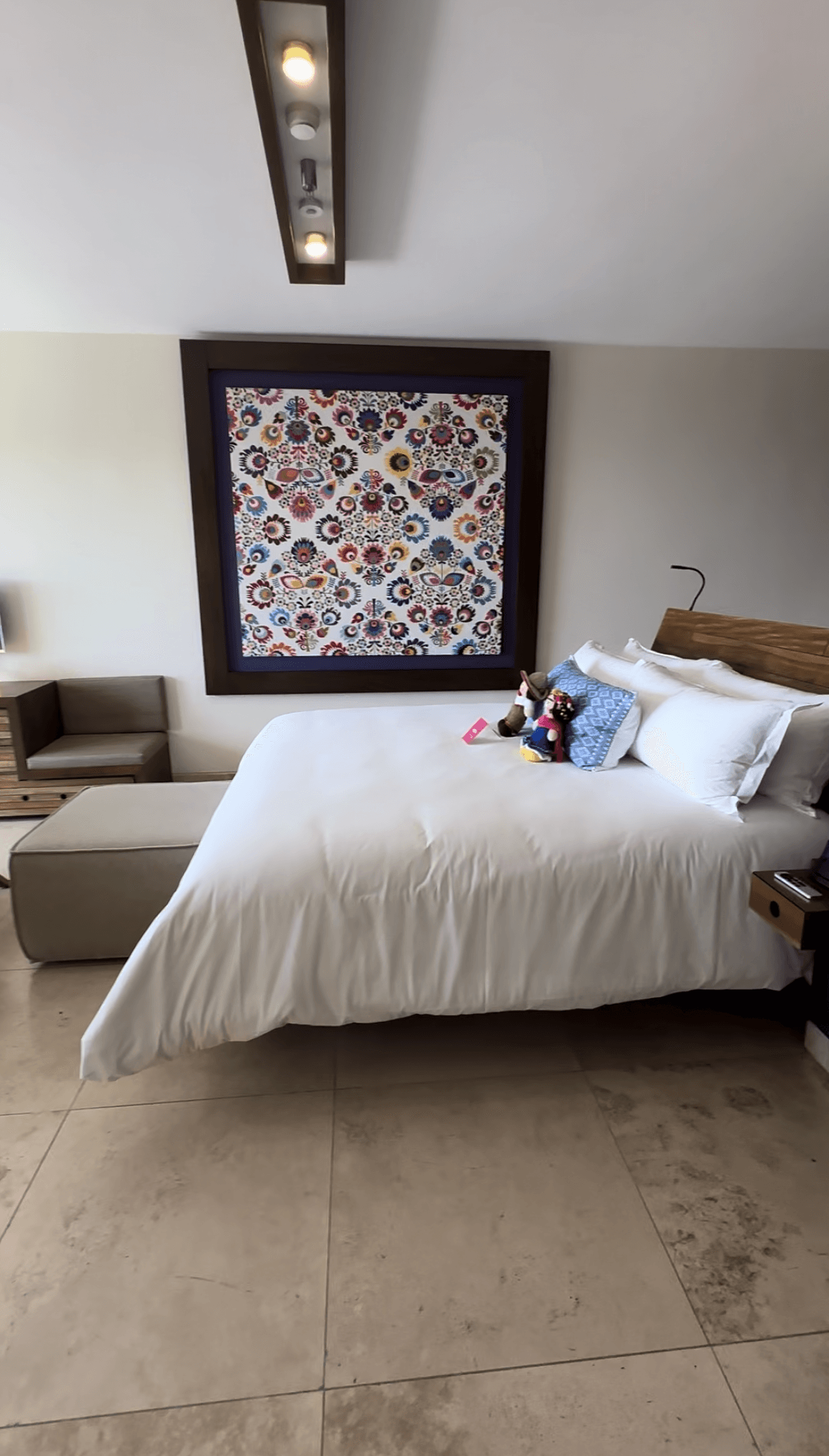 A white bed in a hotel room