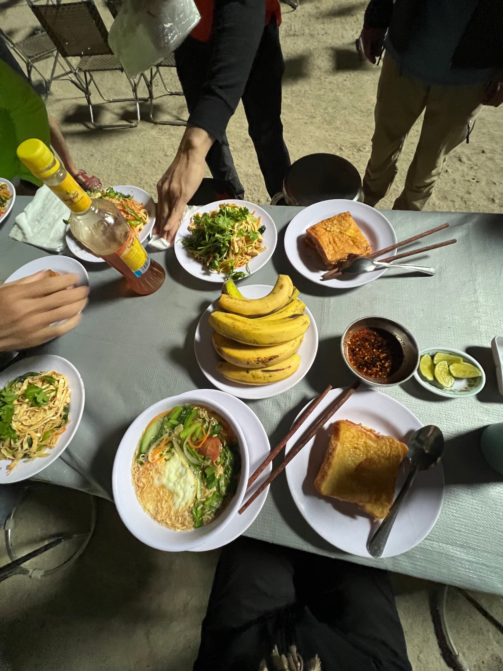 Breakfast in Son Doong with multiple warm plates and fresh fruit.