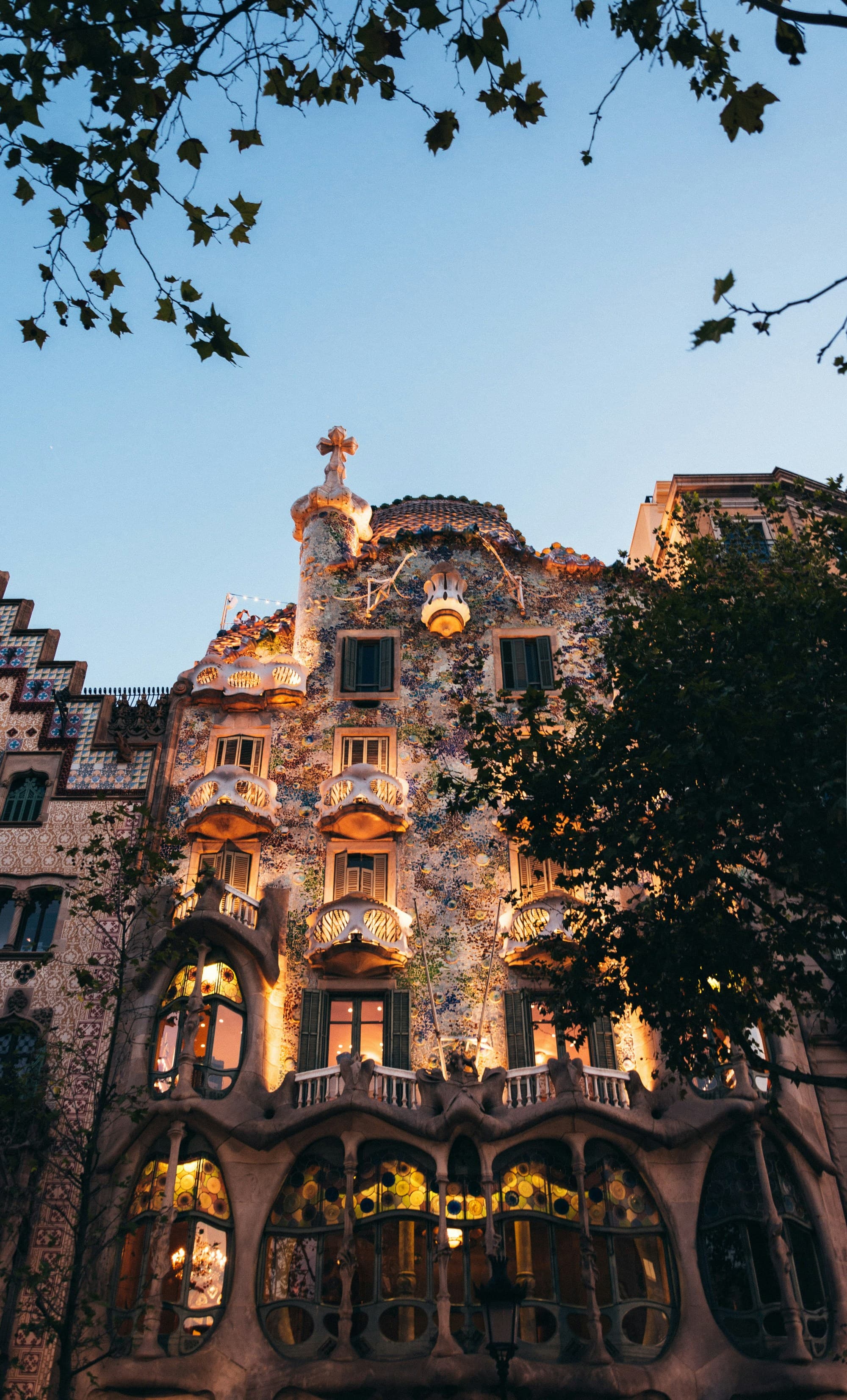 The image showcases the stunning, colorful façade of Casa Batlló, a masterpiece of modernist architecture by Antoni Gaudí in Barcelona.