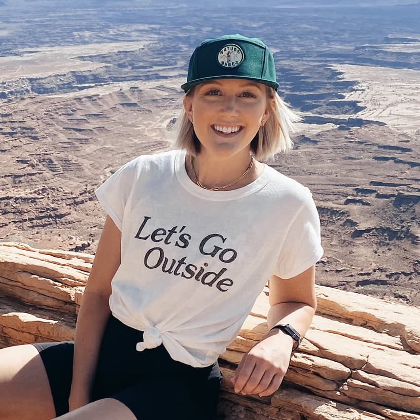 Fora Advisor Tori Petry sitting against red rocks in front of view.