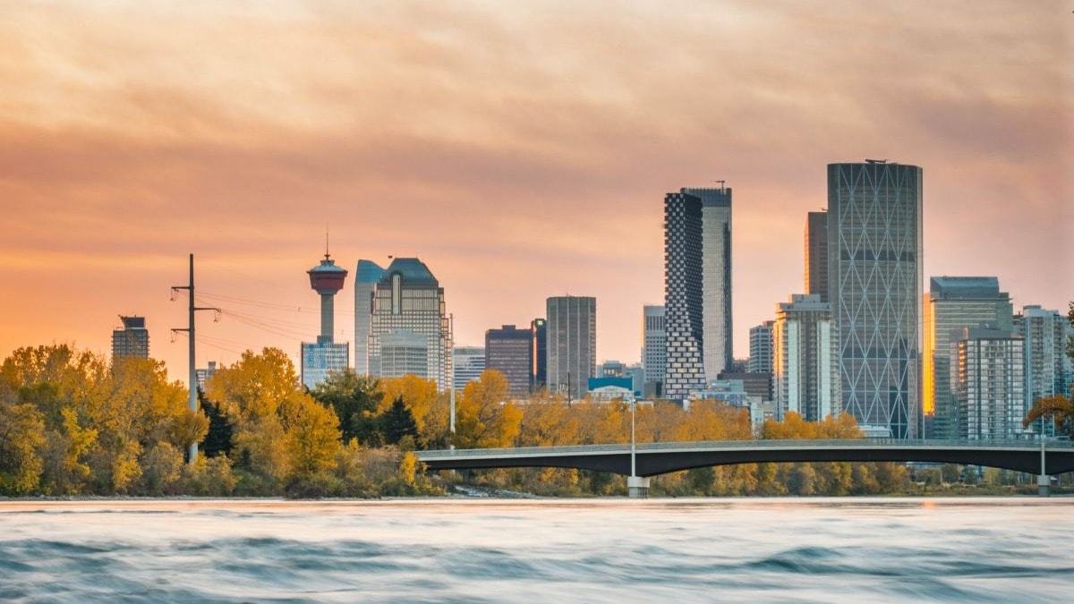 City skyline across the water with a sunset in the background