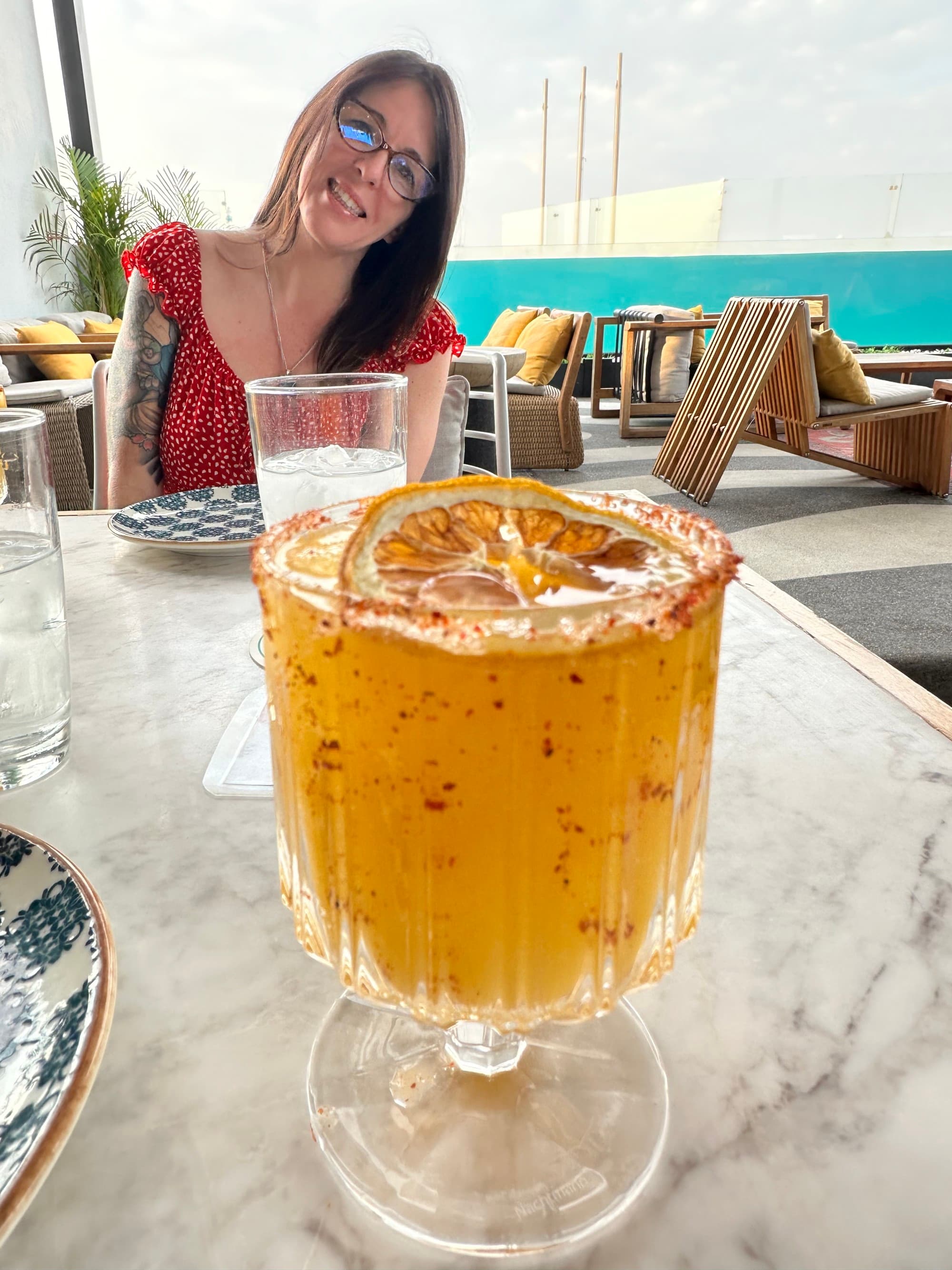 Enjoying spicy mango mezcal margaritas at Cabuya rooftop on a sunny day.