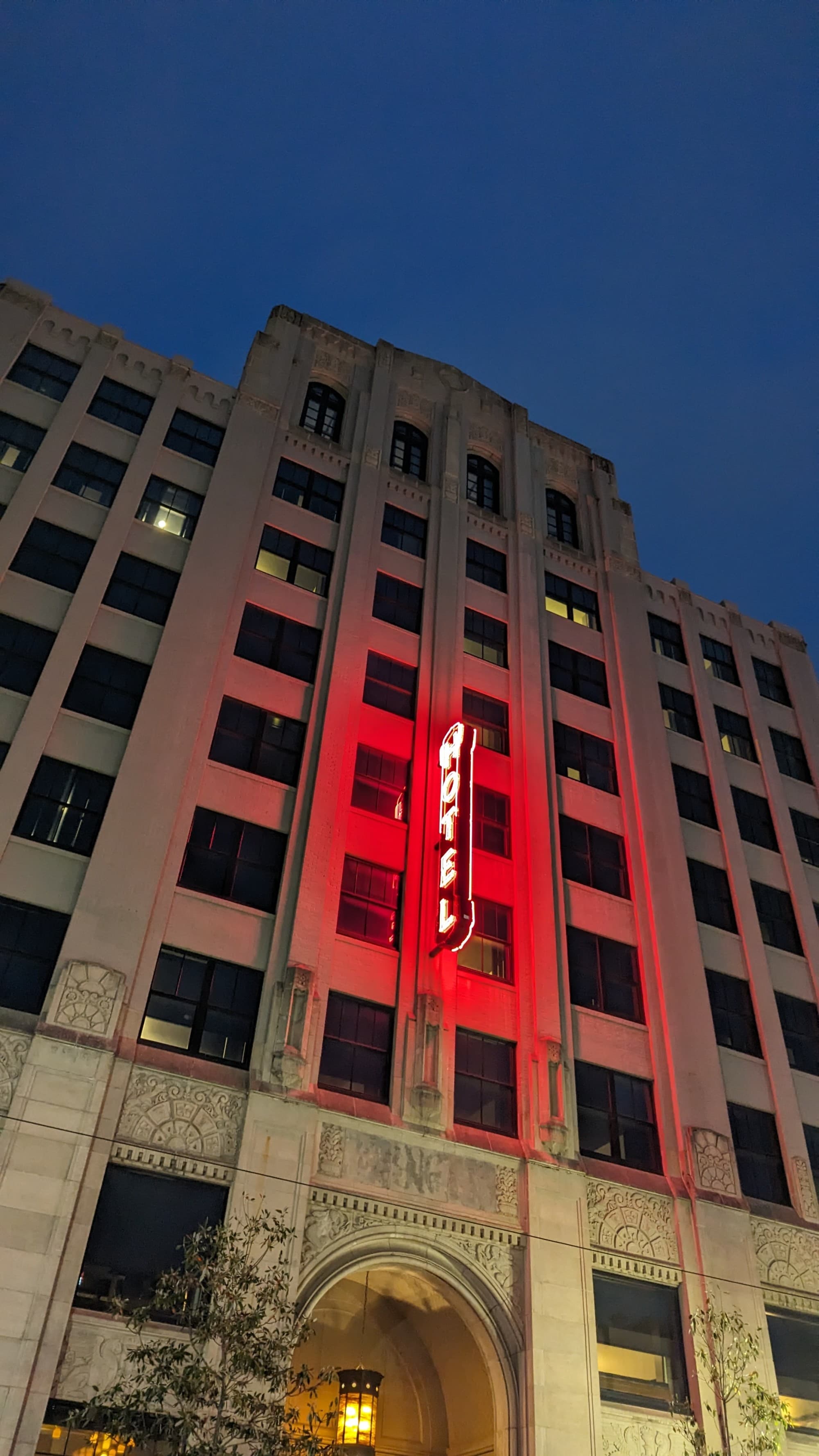 A low-angled view of a hotel building at nighttime