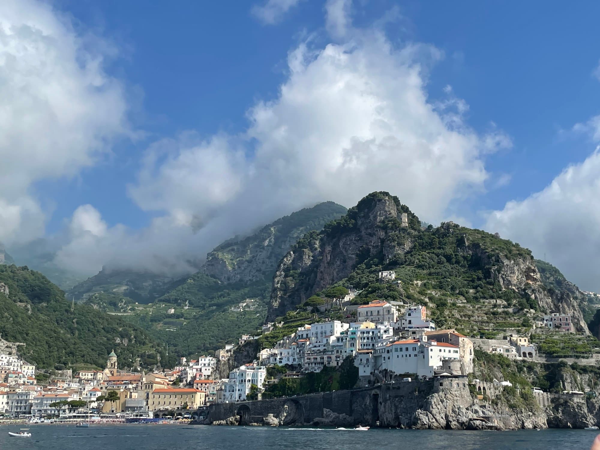 A mountainous coast with groups of buildings on cliff sides