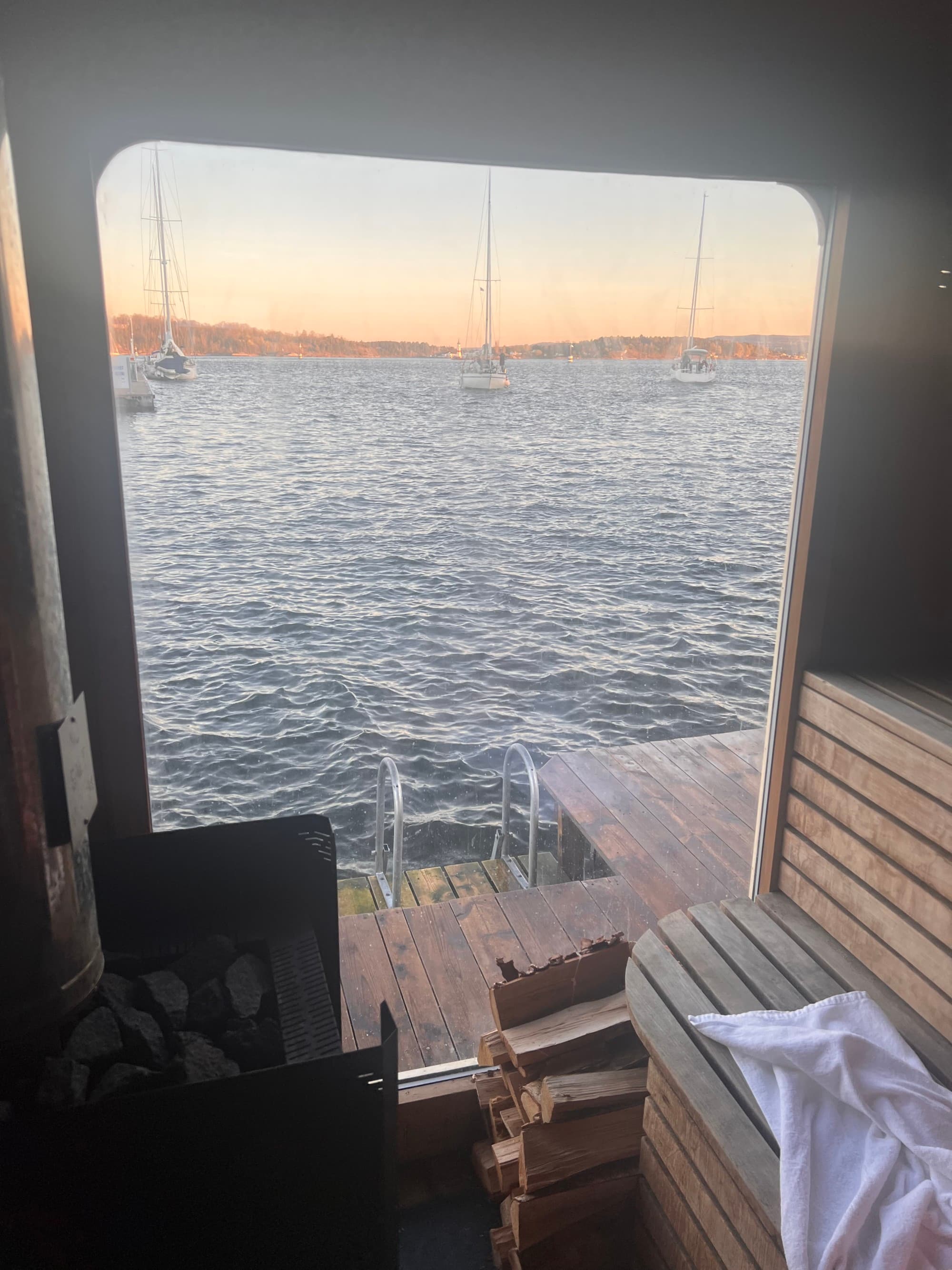 View of the sea through a window during sunset