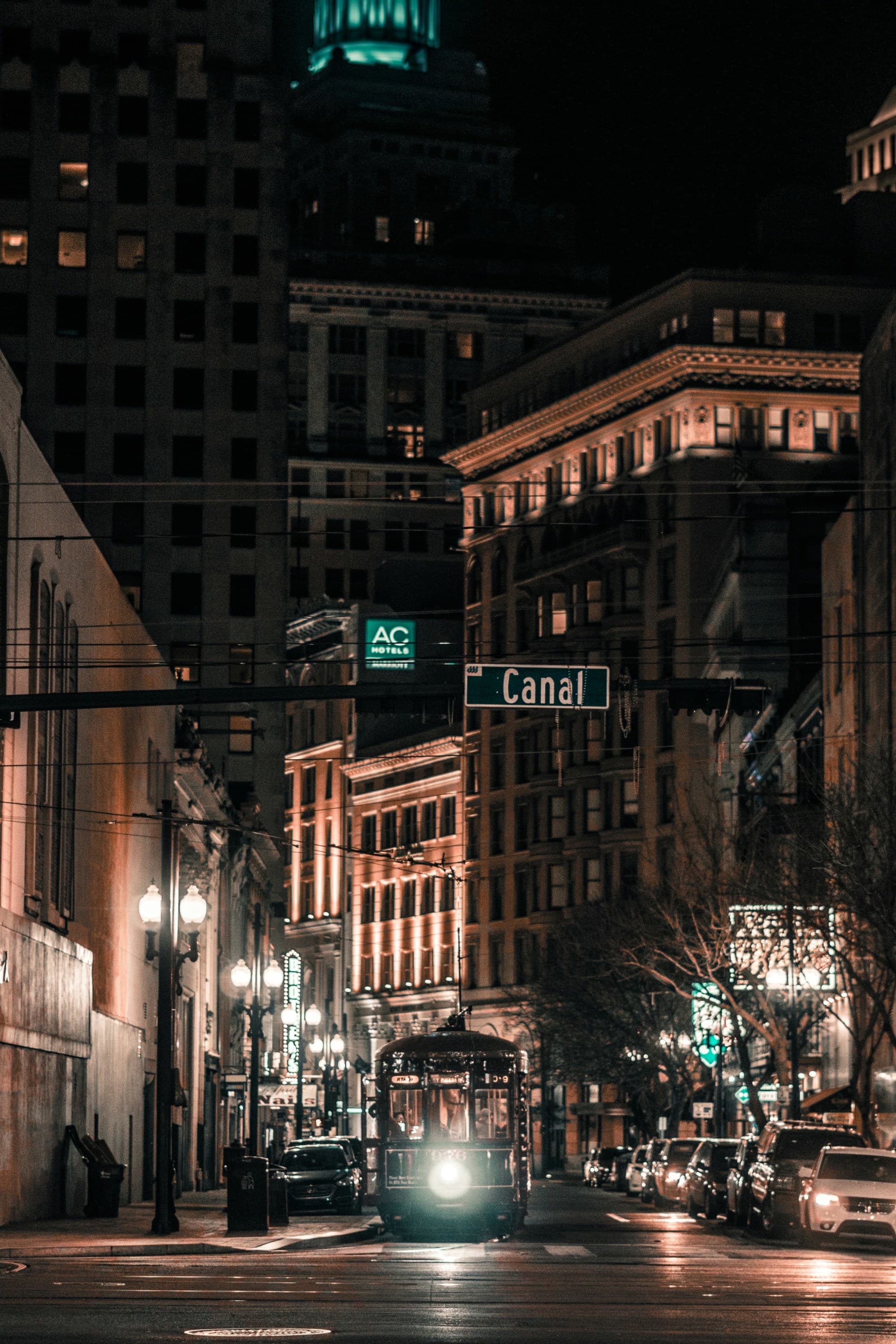 A view of a city street at night with skyscrapers and street lights in the background near the W in New Orleans.