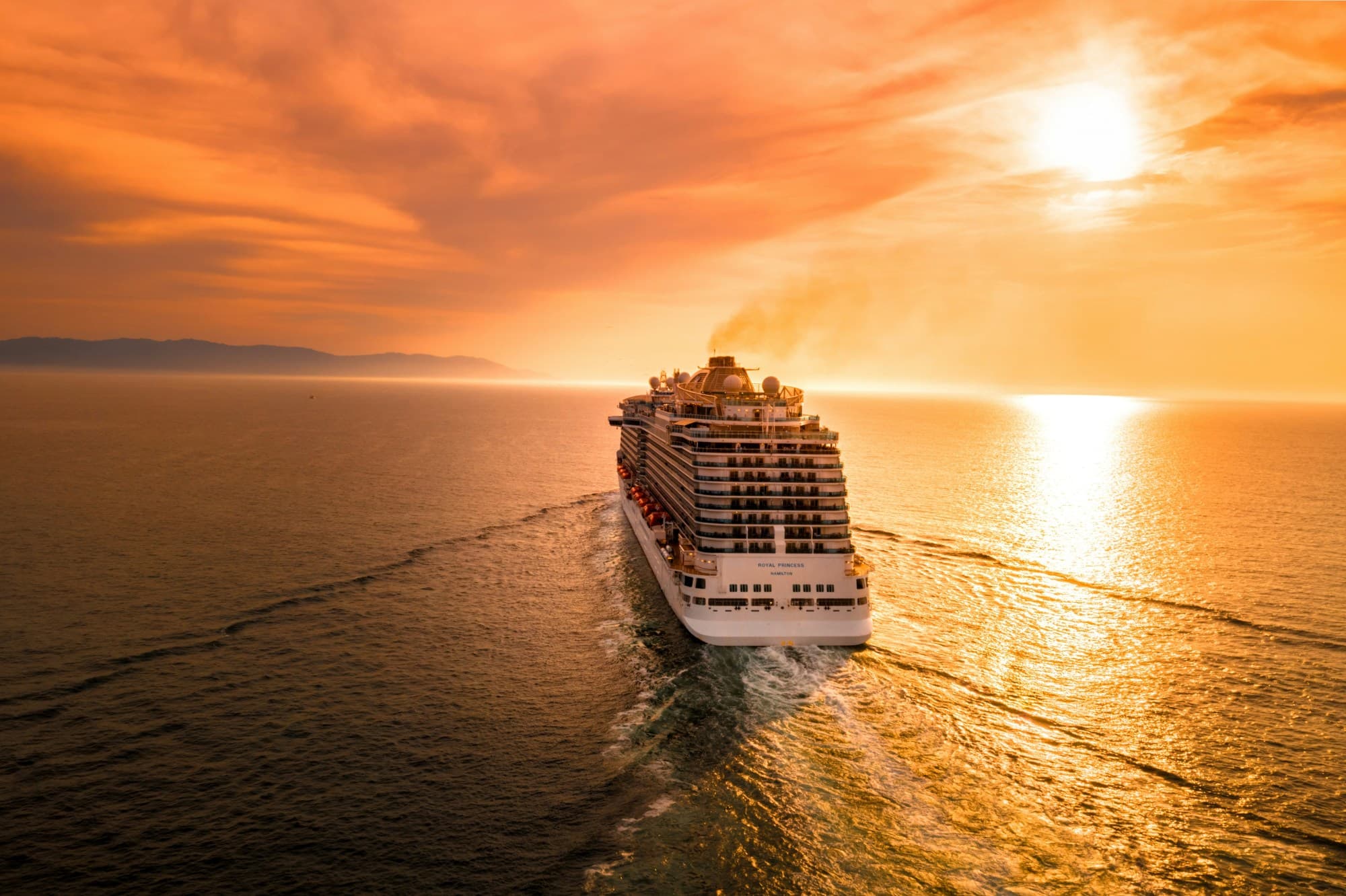 View of a cruise ship in the water at sunset