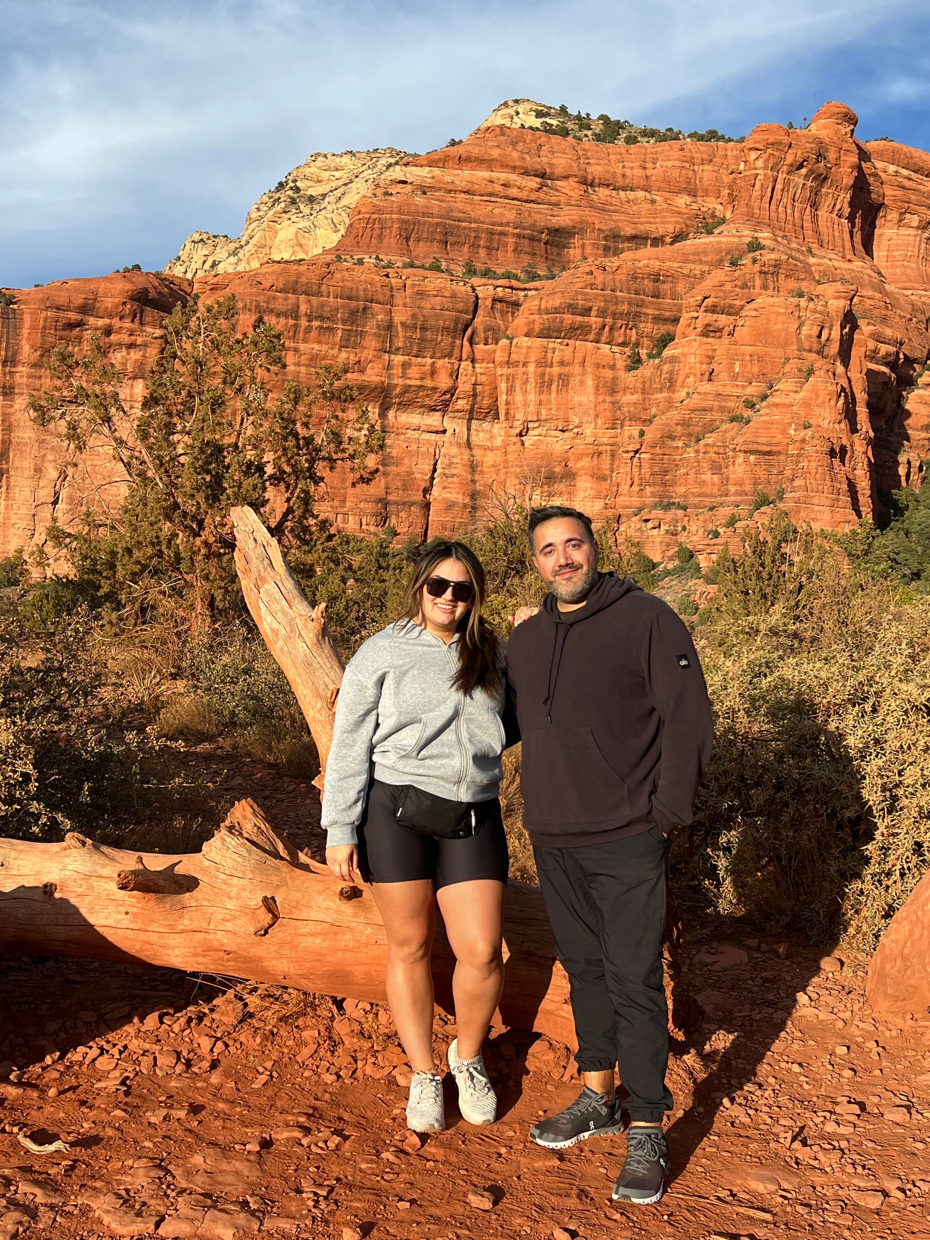 Travel advisor Riva Hanna posing with male companion in front large red rocks
